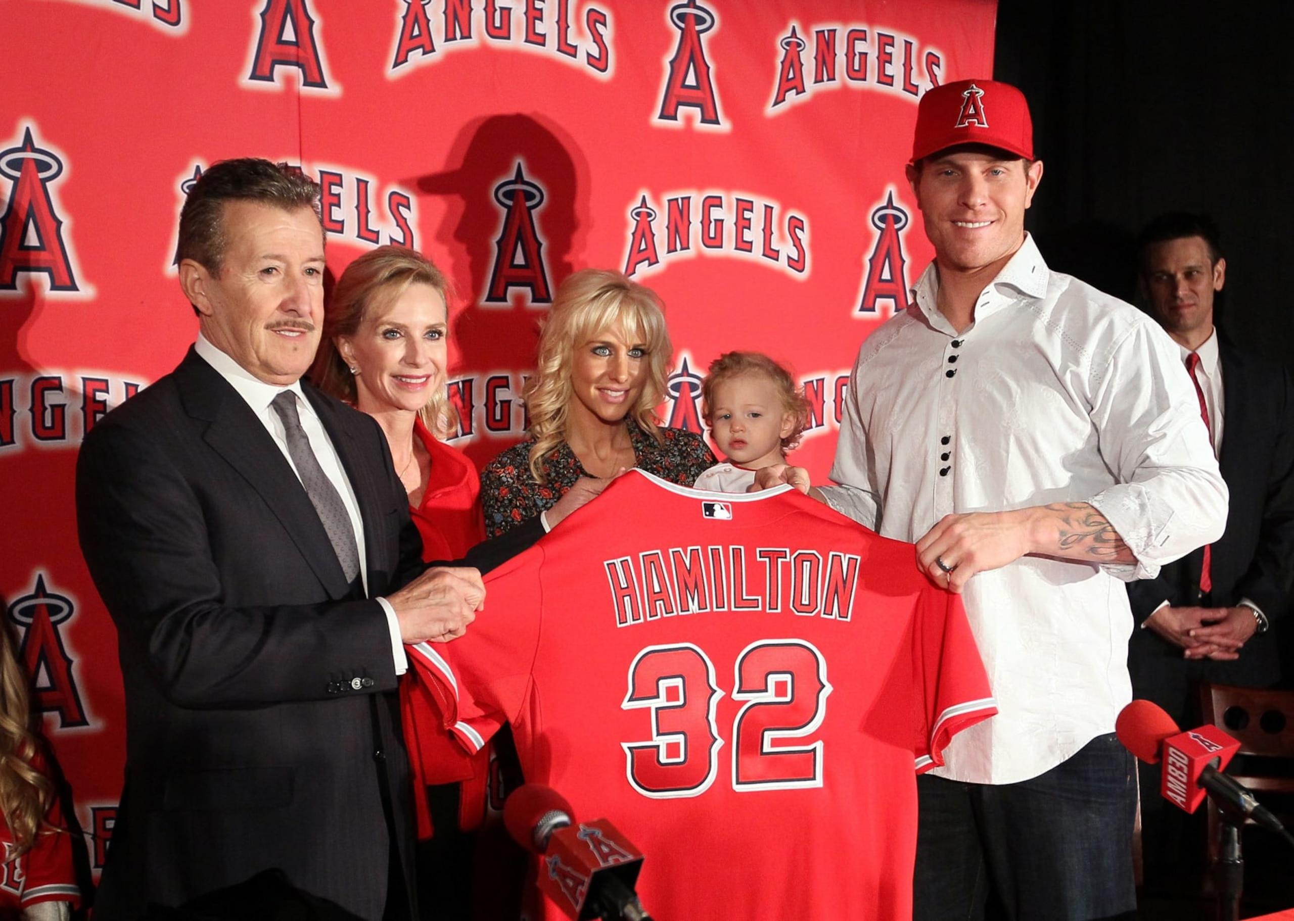 ANAHEIM, CA - DECEMBER 15:  Josh Hamilton #32 of the Los Angeles Angels of Anaheim (R) holds up his new jersey with Angels Owner Arte Moreno during the press conference introducing Hamilton as the team's newest player as wife Katie, daughter Stella Faith and Carole Moreno look on from the background at ESPN Zone at Downtown Disney on December 15, 2012 in Anaheim, California.  (Photo by Victor Decolongon/Getty Images)