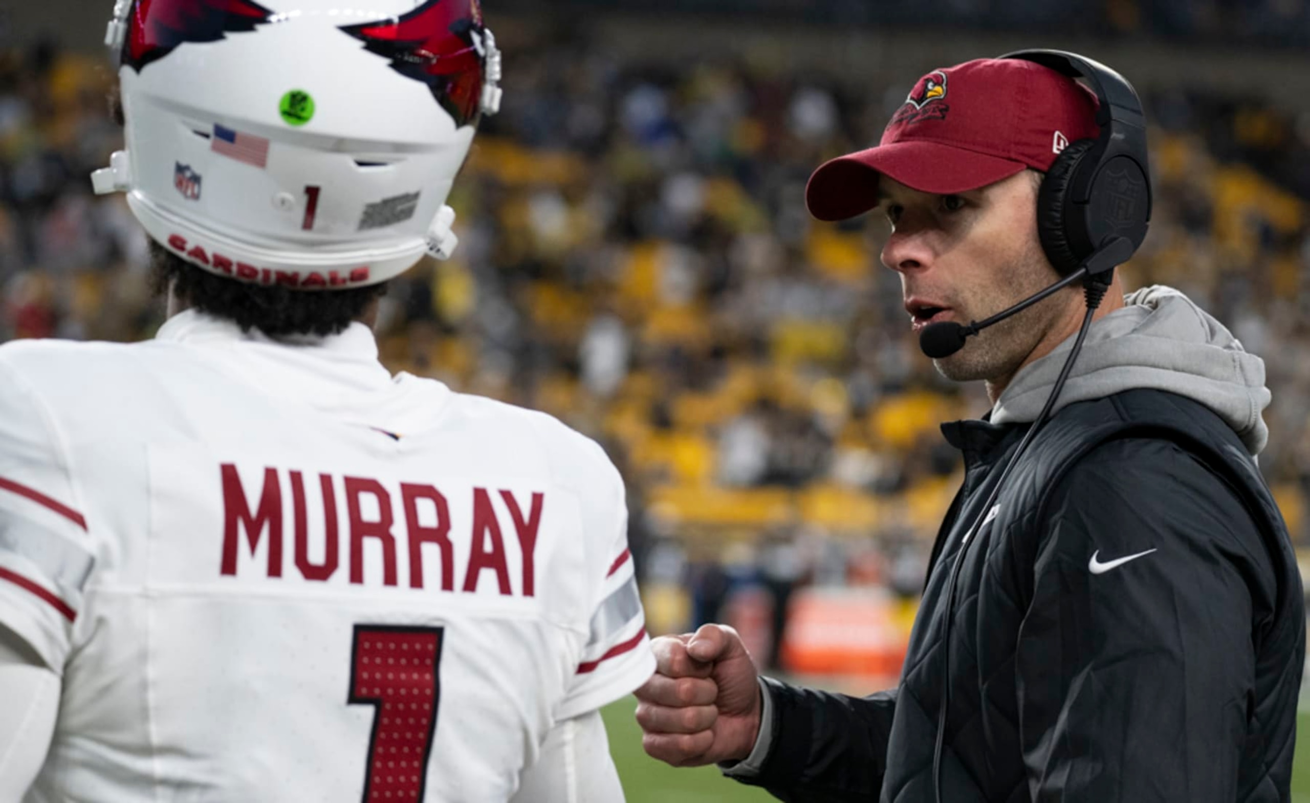 Head coach Jonathan Gannon talking to Kyler Murray