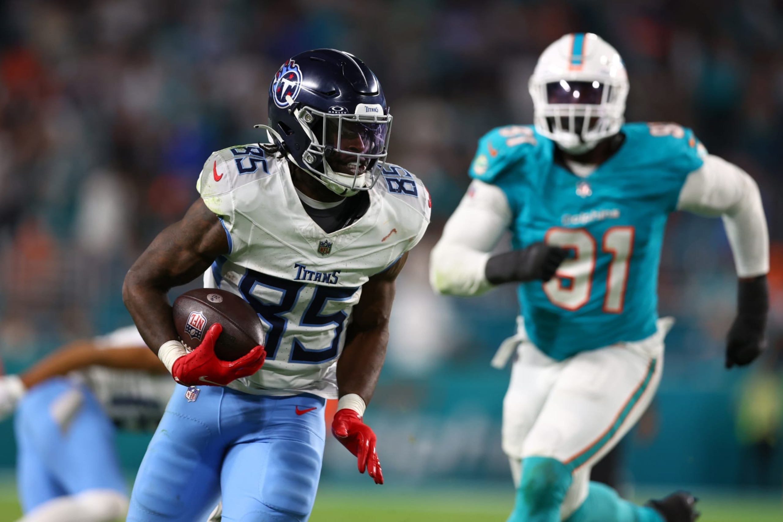 MIAMI GARDENS, FLORIDA - DECEMBER 11: Chigoziem Okonkwo #85 of the Tennessee Titans runs the ball in the second half at Hard Rock Stadium on December 11, 2023 in Miami Gardens, Florida. (Photo by Megan Briggs/Getty Images)