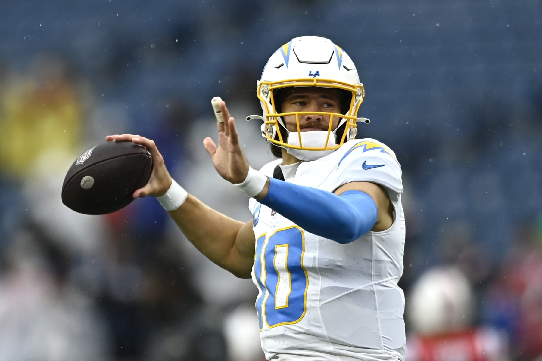 FOXBOROUGH, MASSACHUSETTS - DECEMBER 03: Justin Herbert #10 of the Los Angeles Chargers warms up before the game against the New England Patriots at Gillette Stadium on December 03, 2023 in Foxborough, Massachusetts. (Photo by Billie Weiss/Getty Images)