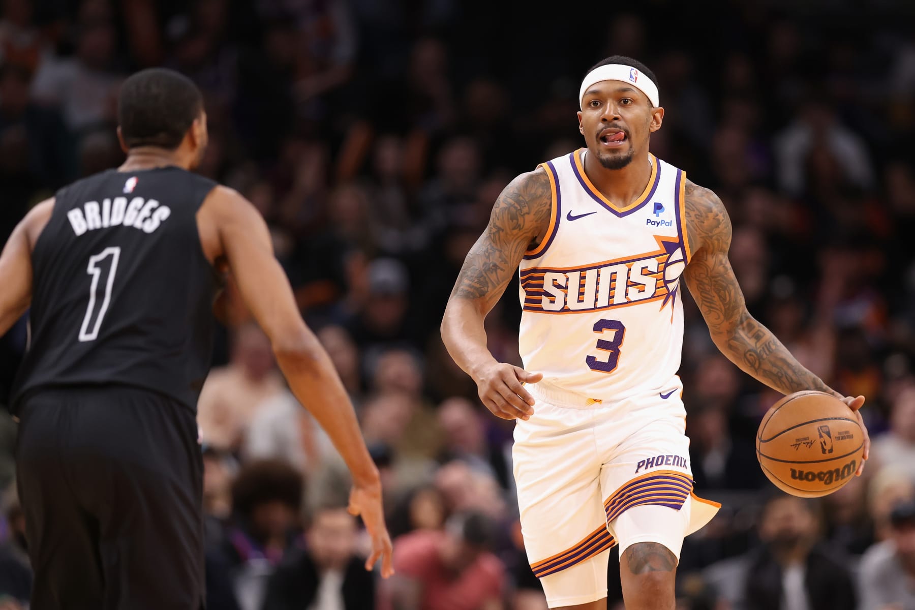 PHOENIX, ARIZONA - DECEMBER 13: Bradley Beal #3 of the Phoenix Suns handles the ball against Mikal Bridges #1 of the Brooklyn Nets during the first half of the NBA game at Footprint Center on December 13, 2023 in Phoenix, Arizona. NOTE TO USER: User expressly acknowledges and agrees that, by downloading and or using this photograph, User is consenting to the terms and conditions of the Getty Images License Agreement.  (Photo by Christian Petersen/Getty Images)