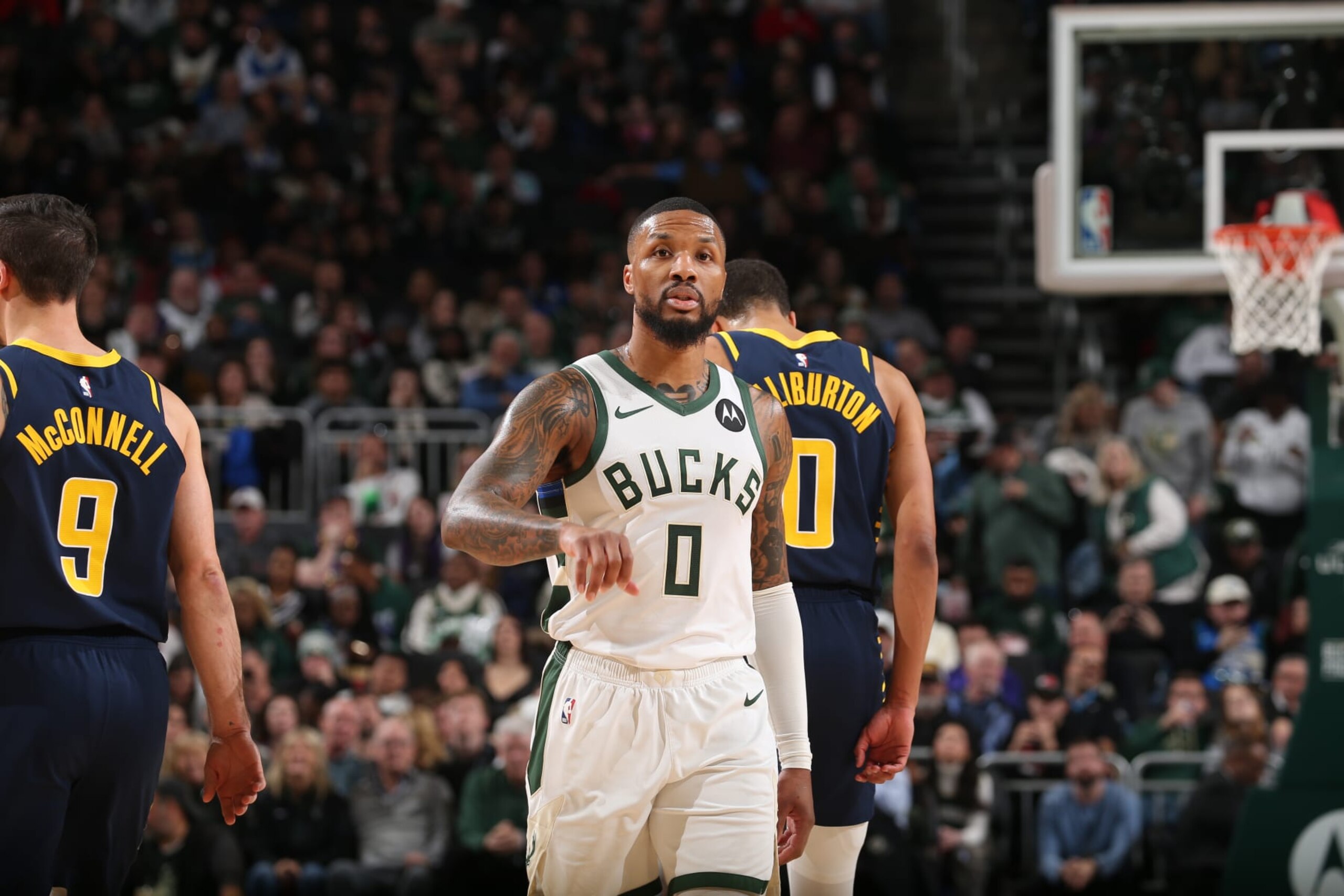 MILWAUKEE, WI - DECEMBER 13: Damian Lillard #0 of the Milwaukee Bucks looks on during the game against the Indiana Pacers on December 13, 2023 at the Fiserv Forum Center in Milwaukee, Wisconsin. NOTE TO USER: User expressly acknowledges and agrees that, by downloading and or using this Photograph, user is consenting to the terms and conditions of the Getty Images License Agreement. Mandatory Copyright Notice: Copyright 2023 NBAE (Photo by Gary Dineen/NBAE via Getty Images). MILWAUKEE, WI - DECEMBER 13: Damian Lillard #0 of the Milwaukee Bucks looks on during the game against the Indiana Pacers on December 13, 2023 at the Fiserv Forum Center in Milwaukee, Wisconsin. NOTE TO USER: User expressly acknowledges and agrees that, by downloading and or using this Photograph, user is consenting to the terms and conditions of the Getty Images License Agreement. Mandatory Copyright Notice: Copyright 2023 NBAE (Photo by Gary Dineen/NBAE via Getty Images).