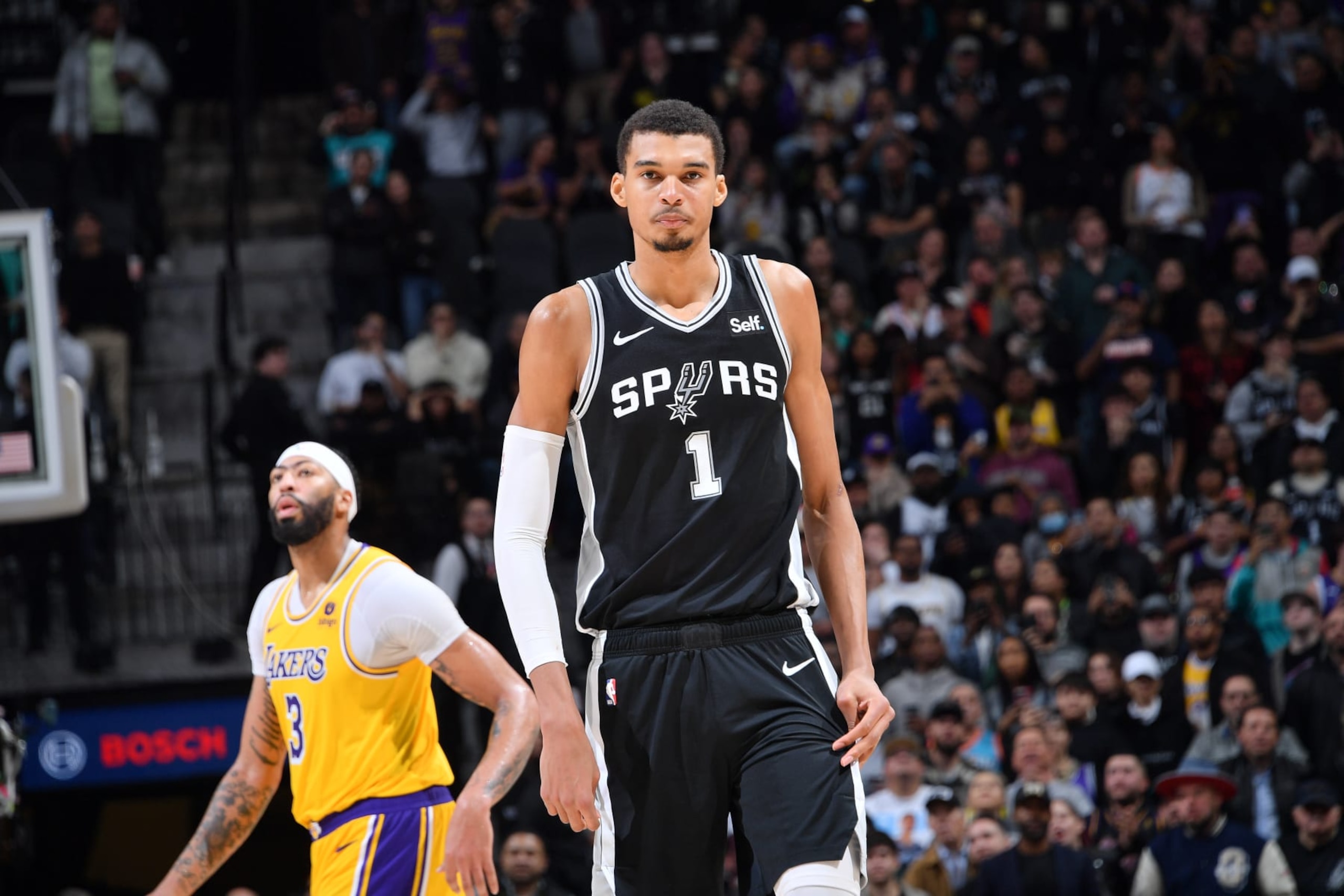 SAN ANTONIO, TX - DECEMBER 13: Anthony Davis #3 of the Los Angeles Lakers and Victor Wembanyama #1 of the San Antonio Spurs look on during the game on December 13, 2023 at the Frost Bank Center in San Antonio, Texas. NOTE TO USER: User expressly acknowledges and agrees that, by downloading and or using this photograph, user is consenting to the terms and conditions of the Getty Images License Agreement. Mandatory Copyright Notice: Copyright 2023 NBAE (Photos by Michael Gonzales/NBAE via Getty Images)