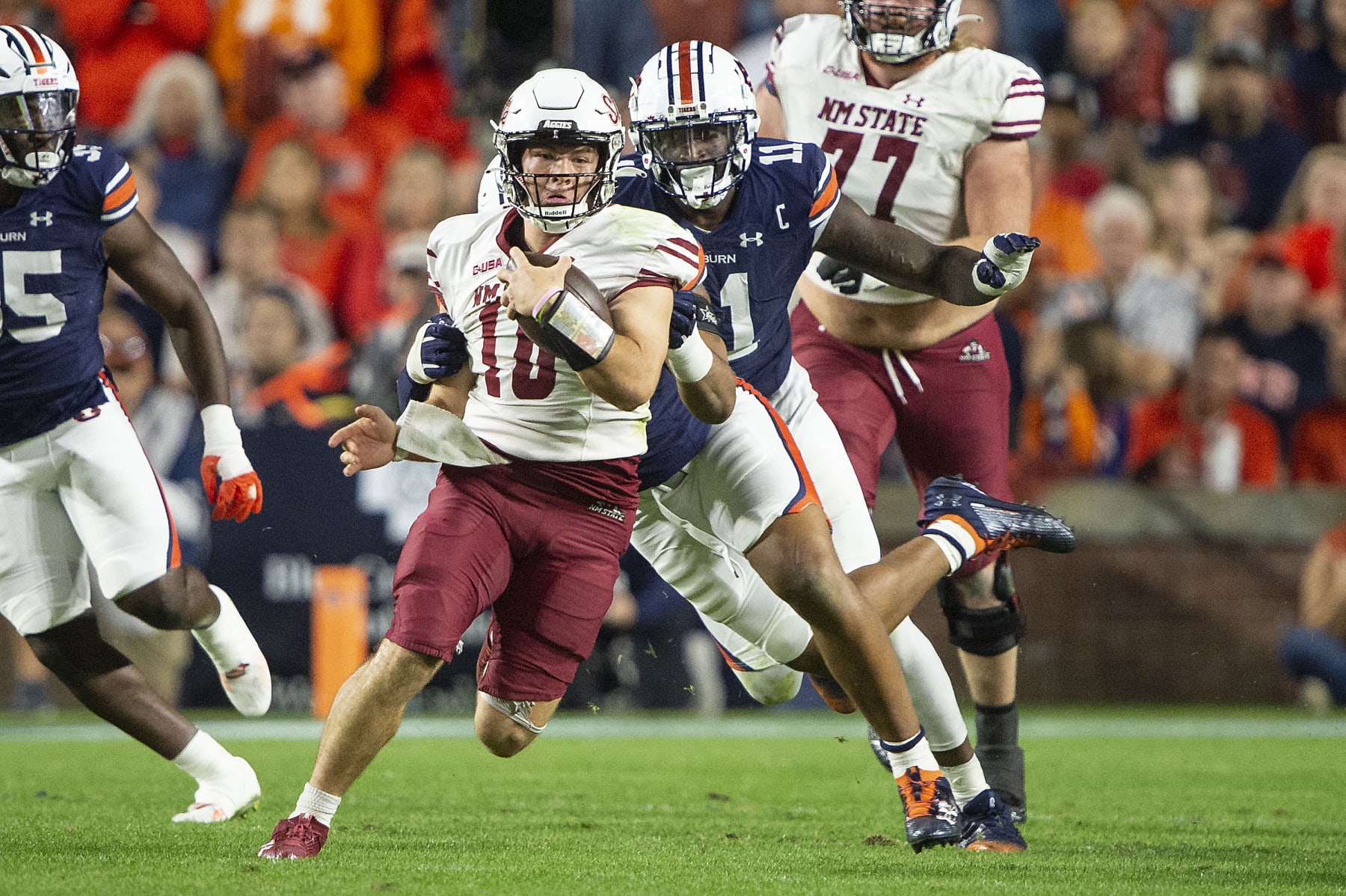AUBURN, ALABAMA - NOVEMBER 18: Quarterback Diego Pavia #10 of the New Mexico State Aggies looks to escape a tackle by defensive lineman Keldric Faulk #15 of the Auburn Tigers during the second half of play at Jordan-Hare Stadium on November 18, 2023 in Auburn, Alabama. (Photo by Michael Chang/Getty Images)
