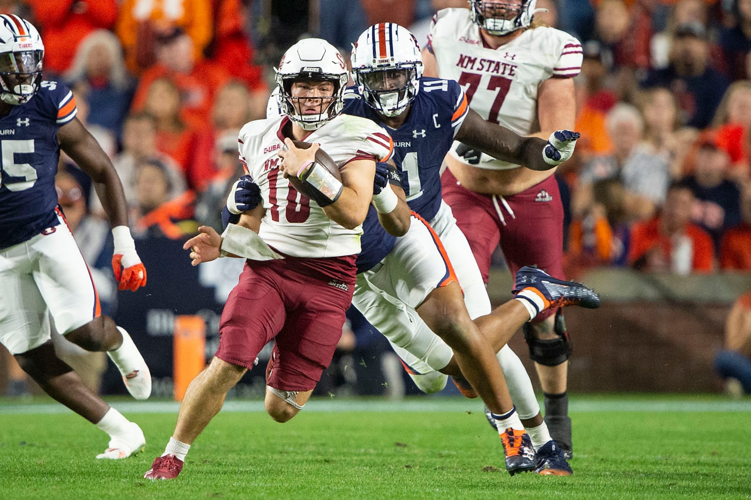 AUBURN, ALABAMA - NOVEMBER 18: Quarterback Diego Pavia #10 of the New Mexico State Aggies looks to escape a tackle by defensive lineman Keldric Faulk #15 of the Auburn Tigers during the second half of play at Jordan-Hare Stadium on November 18, 2023 in Auburn, Alabama. (Photo by Michael Chang/Getty Images) AUBURN, ALABAMA - NOVEMBER 18: Quarterback Diego Pavia #10 of the New Mexico State Aggies looks to escape a tackle by defensive lineman Keldric Faulk #15 of the Auburn Tigers during the second half of play at Jordan-Hare Stadium on November 18, 2023 in Auburn, Alabama. (Photo by Michael Chang/Getty Images)