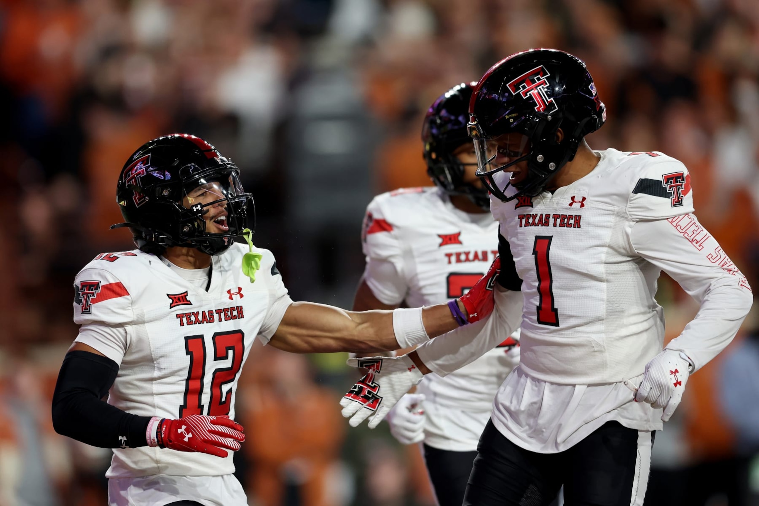 AUSTIN, TEXAS - NOVEMBER 24: Bralyn Lux #12 of the Texas Tech Red Raiders celebrates with Dadrion Taylor-Demerson #1 after an interception in the first half against the Texas Longhorns at Darrell K Royal-Texas Memorial Stadium on November 24, 2023 in Austin, Texas. (Photo by Tim Warner/Getty Images) AUSTIN, TEXAS - NOVEMBER 24: Bralyn Lux #12 of the Texas Tech Red Raiders celebrates with Dadrion Taylor-Demerson #1 after an interception in the first half against the Texas Longhorns at Darrell K Royal-Texas Memorial Stadium on November 24, 2023 in Austin, Texas. (Photo by Tim Warner/Getty Images)