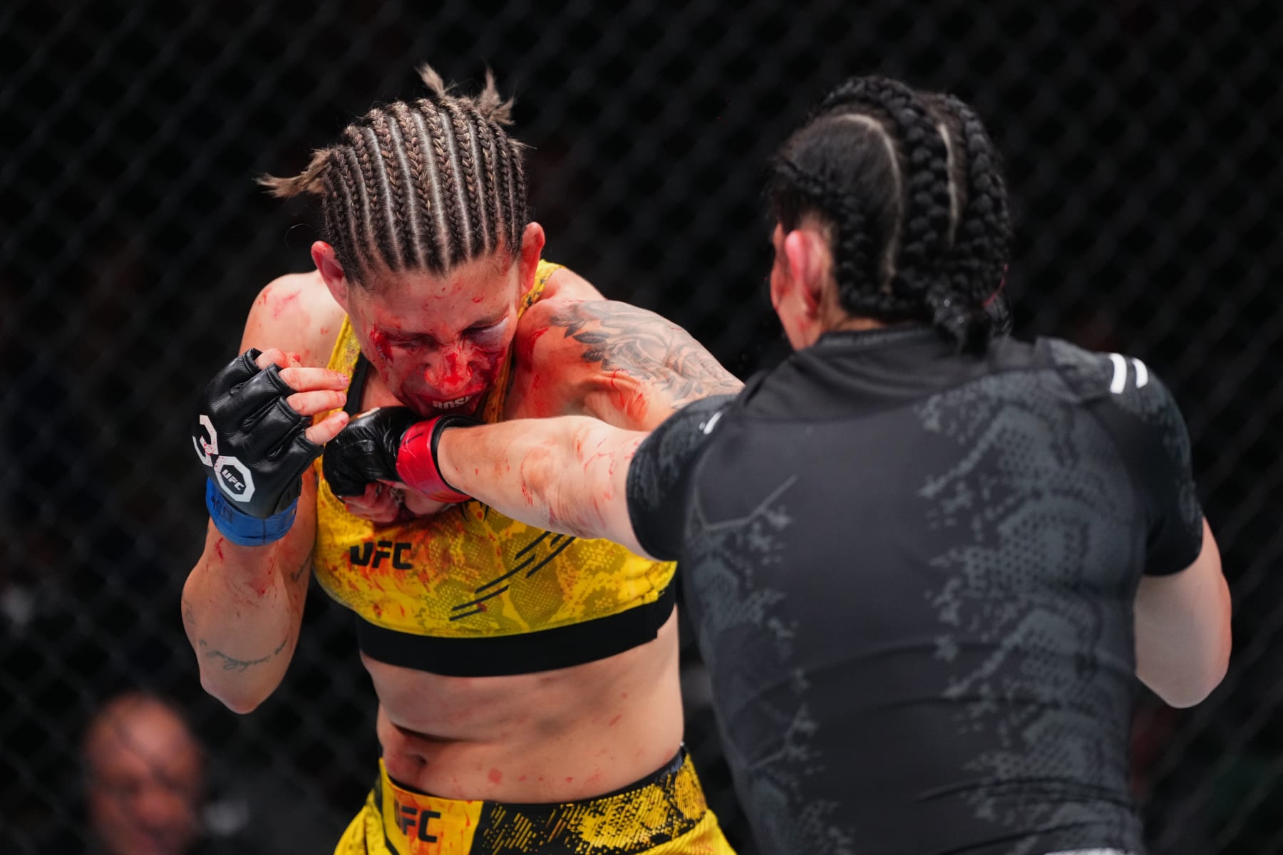 LAS VEGAS, NEVADA - DECEMBER 16: (R-L) Irene Aldana of Mexico punches Karol Rosa of Brazil in a bantamweight fight during the UFC 296 event at T-Mobile Arena on December 16, 2023 in Las Vegas, Nevada. (Photo by Jeff Bottari/Zuffa LLC via Getty Images)