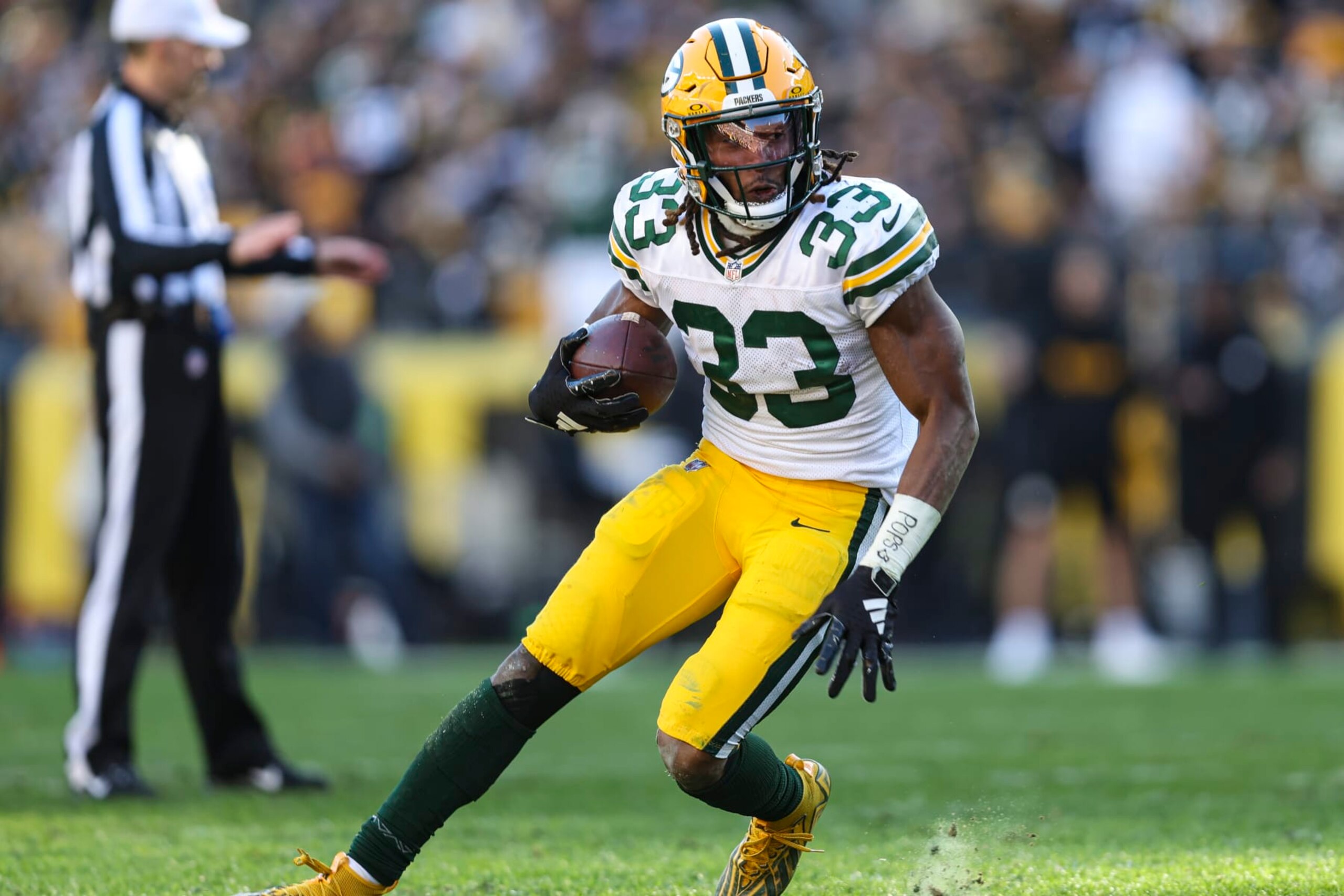PITTSBURGH, PA - NOVEMBER 12: Aaron Jones #33 of the Green Bay Packers runs the ball during an NFL football game against the Pittsburgh Steelers at Acrisure Stadium on November 12, 2023 in Pittsburgh, Pennsylvania. (Photo by Perry Knotts/Getty Images)