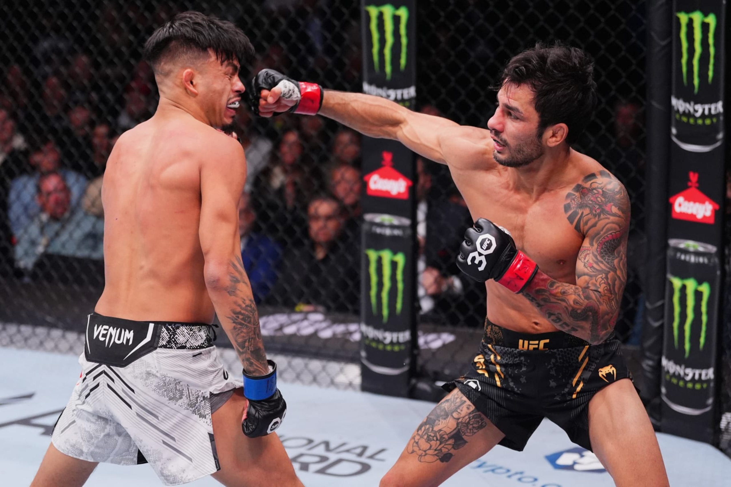 LAS VEGAS, NEVADA - DECEMBER 16: (R-L) Alexandre Pantoja of Brazil punches Brandon Royval in the UFC flyweight championship fight during the UFC 296 event at T-Mobile Arena on December 16, 2023 in Las Vegas, Nevada. (Photo by Jeff Bottari/Zuffa LLC via Getty Images)