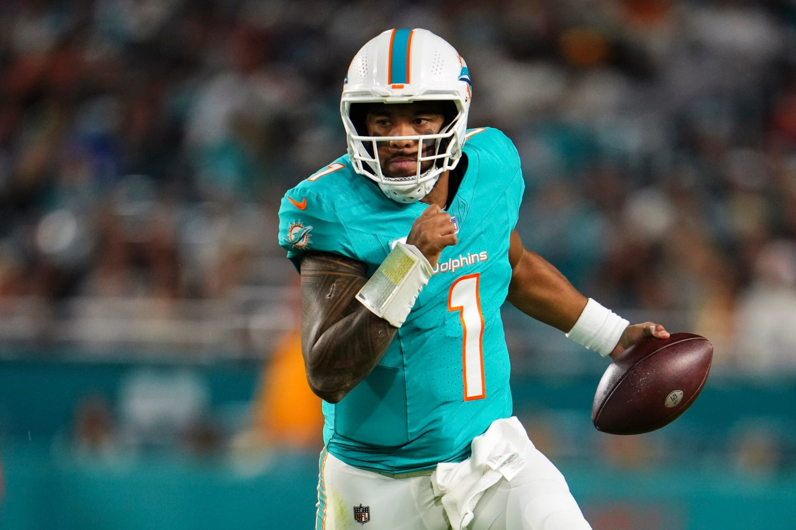 MIAMI GARDENS, FL - DECEMBER 11: Tua Tagovailoa #1 of the Miami Dolphins scrambles out of the pocket during an NFL football game against the Tennessee Titans at Hard Rock Stadium on December 11, 2023 in Miami Gardens, Florida. (Photo by Cooper Neill/Getty Images) MIAMI GARDENS, FL - DECEMBER 11: Tua Tagovailoa #1 of the Miami Dolphins scrambles out of the pocket during an NFL football game against the Tennessee Titans at Hard Rock Stadium on December 11, 2023 in Miami Gardens, Florida. (Photo by Cooper Neill/Getty Images)
