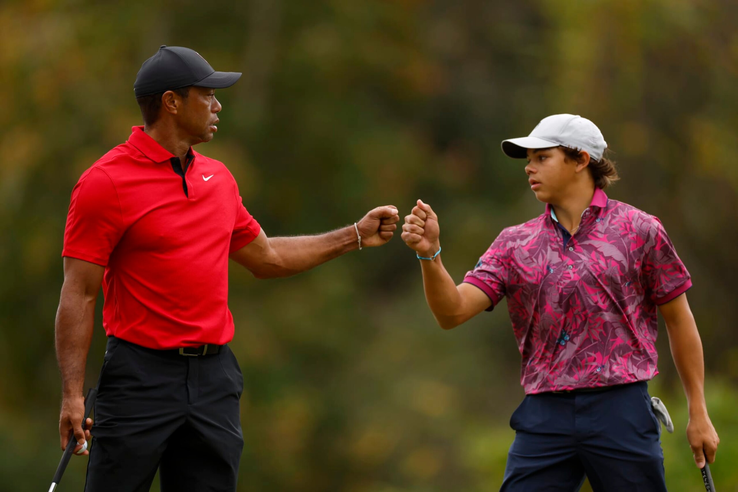 ORLANDO, FLORIDA - DECEMBER 17: Tiger Woods of the United States and son, Charlie Woods, react on the 15th green during the final round of the PNC Championship at The Ritz-Carlton Golf Club on December 17, 2023 in Orlando, Florida. (Photo by Mike Ehrmann/Getty Images)