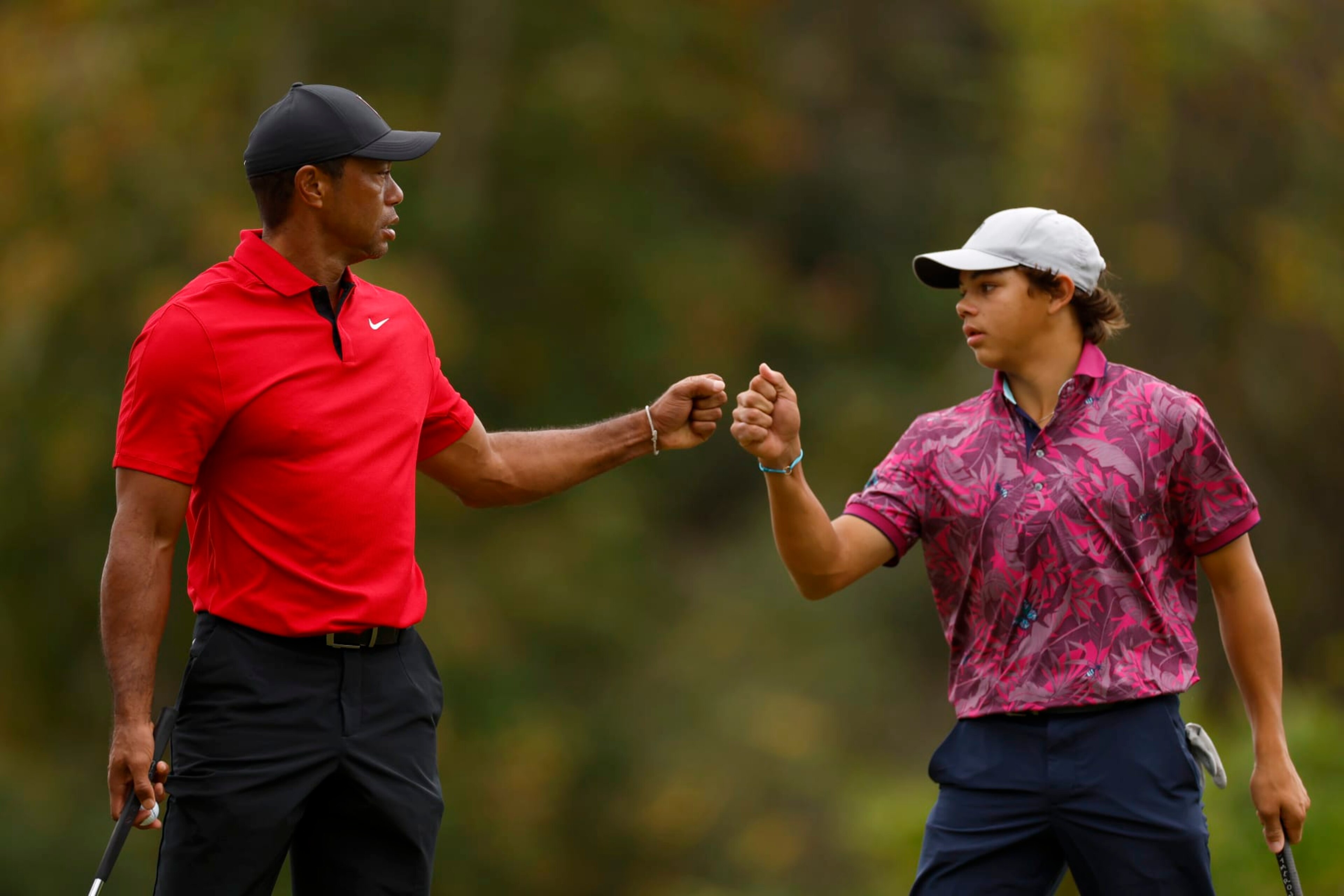 ORLANDO, FLORIDA - DECEMBER 17: Tiger Woods of the United States and son, Charlie Woods, react on the 15th green during the final round of the PNC Championship at The Ritz-Carlton Golf Club on December 17, 2023 in Orlando, Florida. (Photo by Mike Ehrmann/Getty Images)