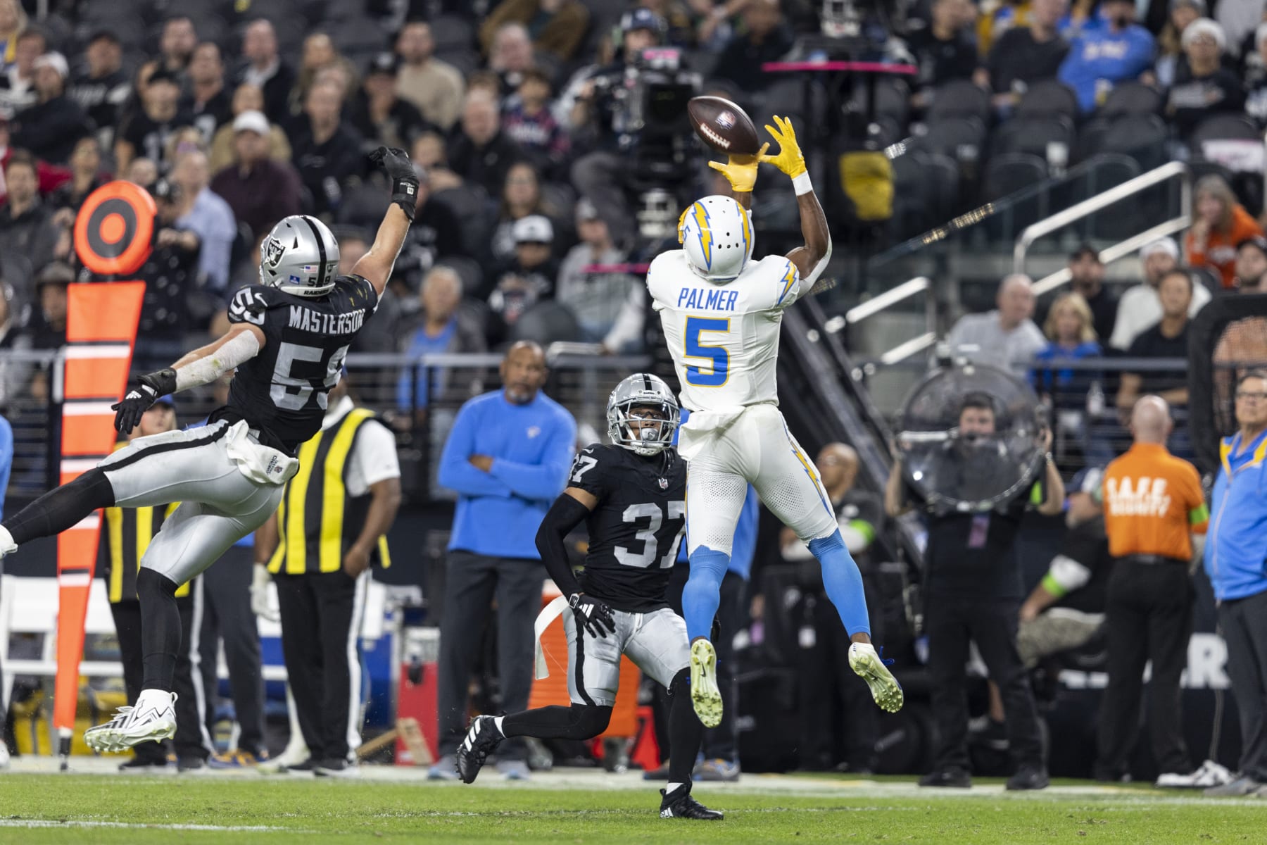 LAS VEGAS, NEVADA - DECEMBER 14: Joshua Palmer #5 of the Los Angeles Chargers completes a pass against Luke Masterson #59 of the Las Vegas Raiders during an NFL football game between the Las Vegas Raiders and the Los Angeles Chargers at Allegiant Stadium on December 14, 2023 in Las Vegas, Nevada. (Photo by Michael Owens/Getty Images)