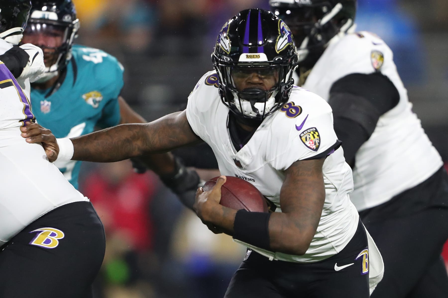 JACKSONVILLE, FLORIDA - DECEMBER 17: Lamar Jackson #8 of the Baltimore Ravens runs with the ball against the Jacksonville Jaguars during the first quarter at EverBank Stadium on December 17, 2023 in Jacksonville, Florida. (Photo by Courtney Culbreath/Getty Images)