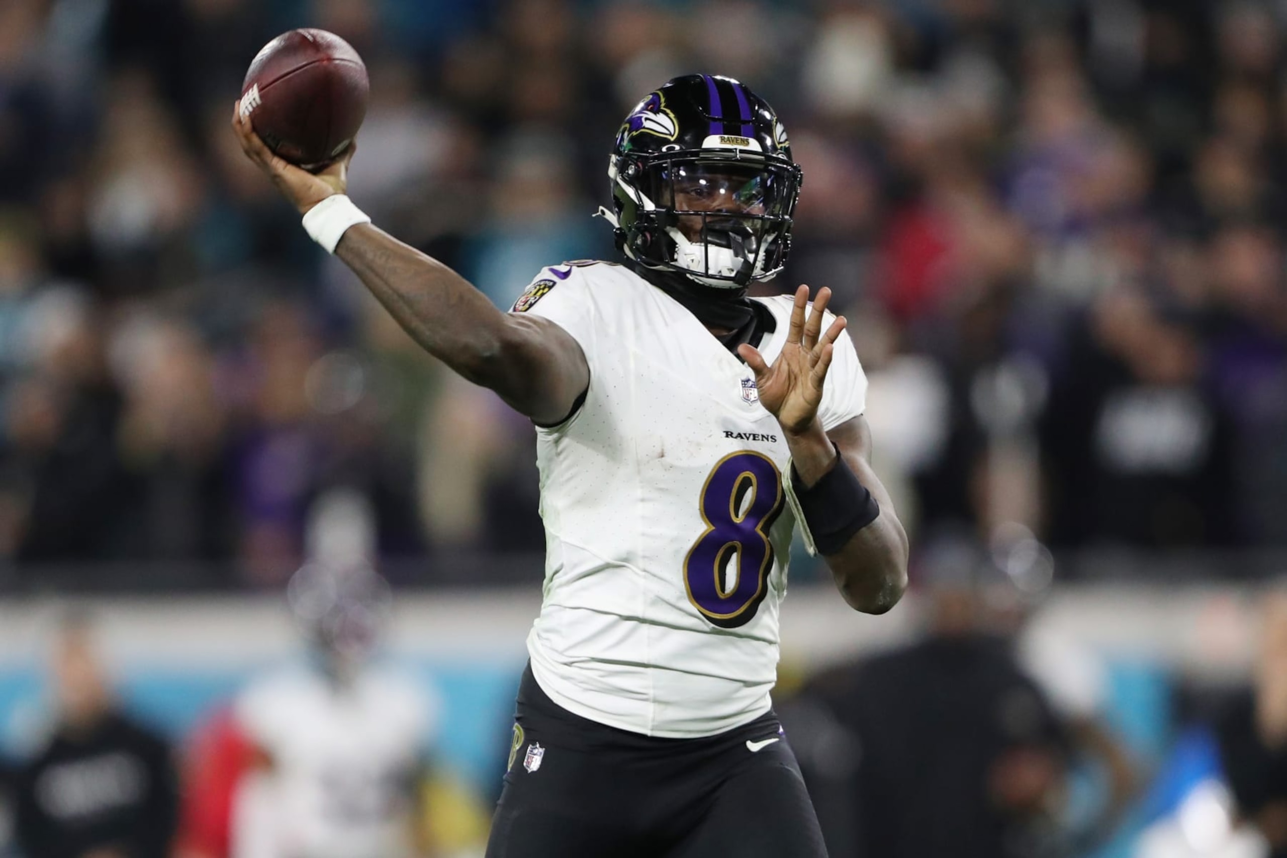 JACKSONVILLE, FLORIDA - DECEMBER 17: Lamar Jackson #8 of the Baltimore Ravens throws a touchdown pass against the Jacksonville Jaguars during the second quarter at EverBank Stadium on December 17, 2023 in Jacksonville, Florida. (Photo by Courtney Culbreath/Getty Images)