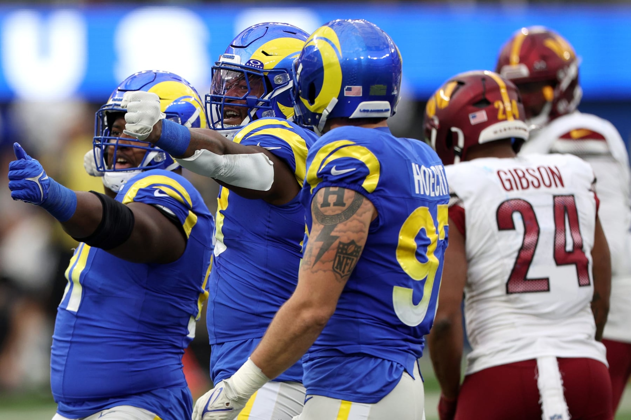 INGLEWOOD, CALIFORNIA - DECEMBER 17: Kobie Turner #91 of the Los Angeles Rams and Marquise Copeland #93 react during the first half of the game against the Washington Commanders at SoFi Stadium on December 17, 2023 in Inglewood, California. (Photo by Harry How/Getty Images)