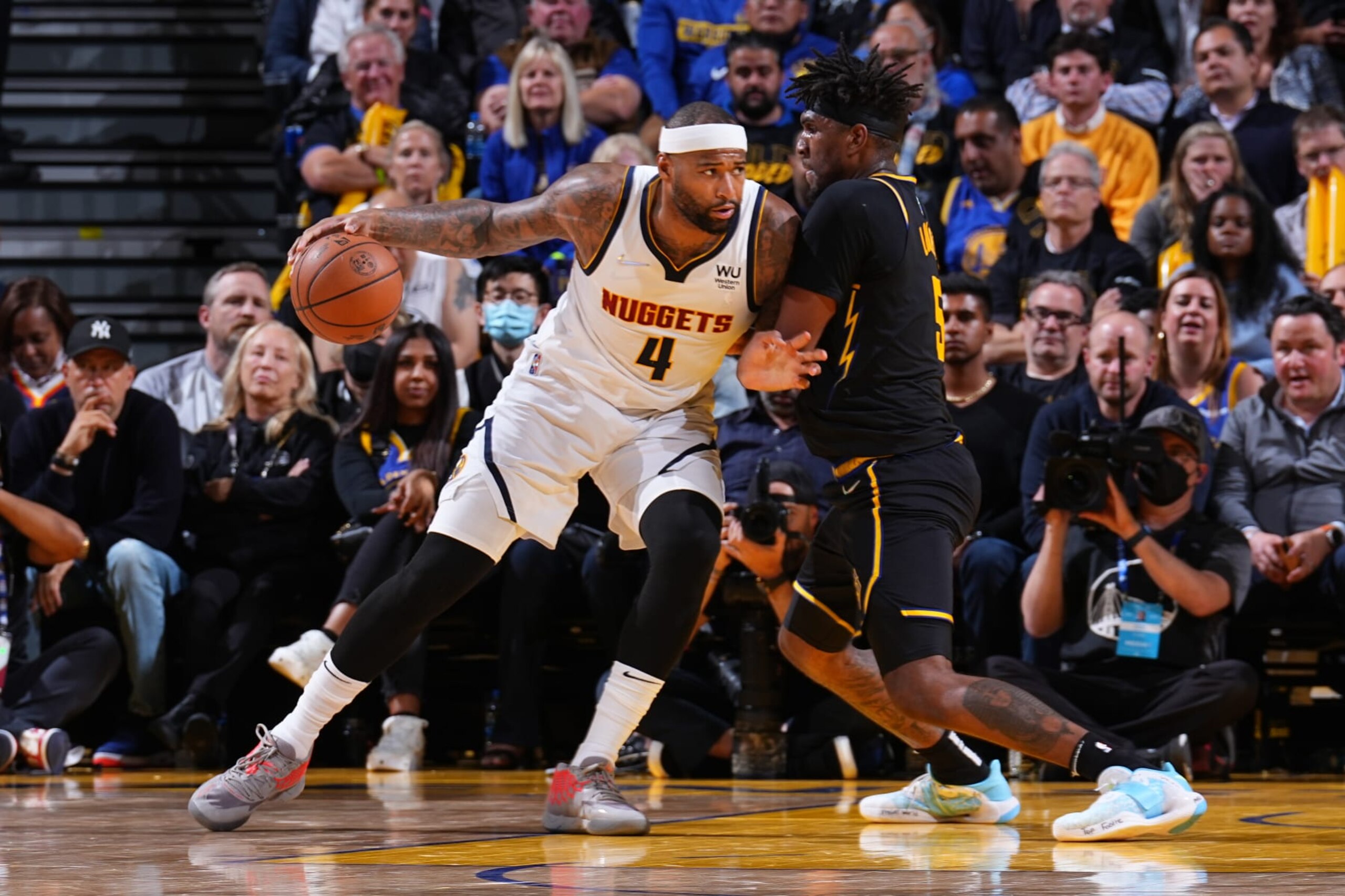 SAN FRANCISCO, CA - APRIL 27: Kevon Looney #5 of the Golden State Warriors plays defense on DeMarcus Cousins #4 of the Denver Nuggets during Round 1 Game 5 of the 2022 NBA Playoffs on April 27, 2022 at Chase Center in San Francisco, California. NOTE TO USER: User expressly acknowledges and agrees that, by downloading and or using this photograph, user is consenting to the terms and conditions of Getty Images License Agreement. Mandatory Copyright Notice: Copyright 2022 NBAE (Photo by Garrett Ellwood/NBAE via Getty Images)