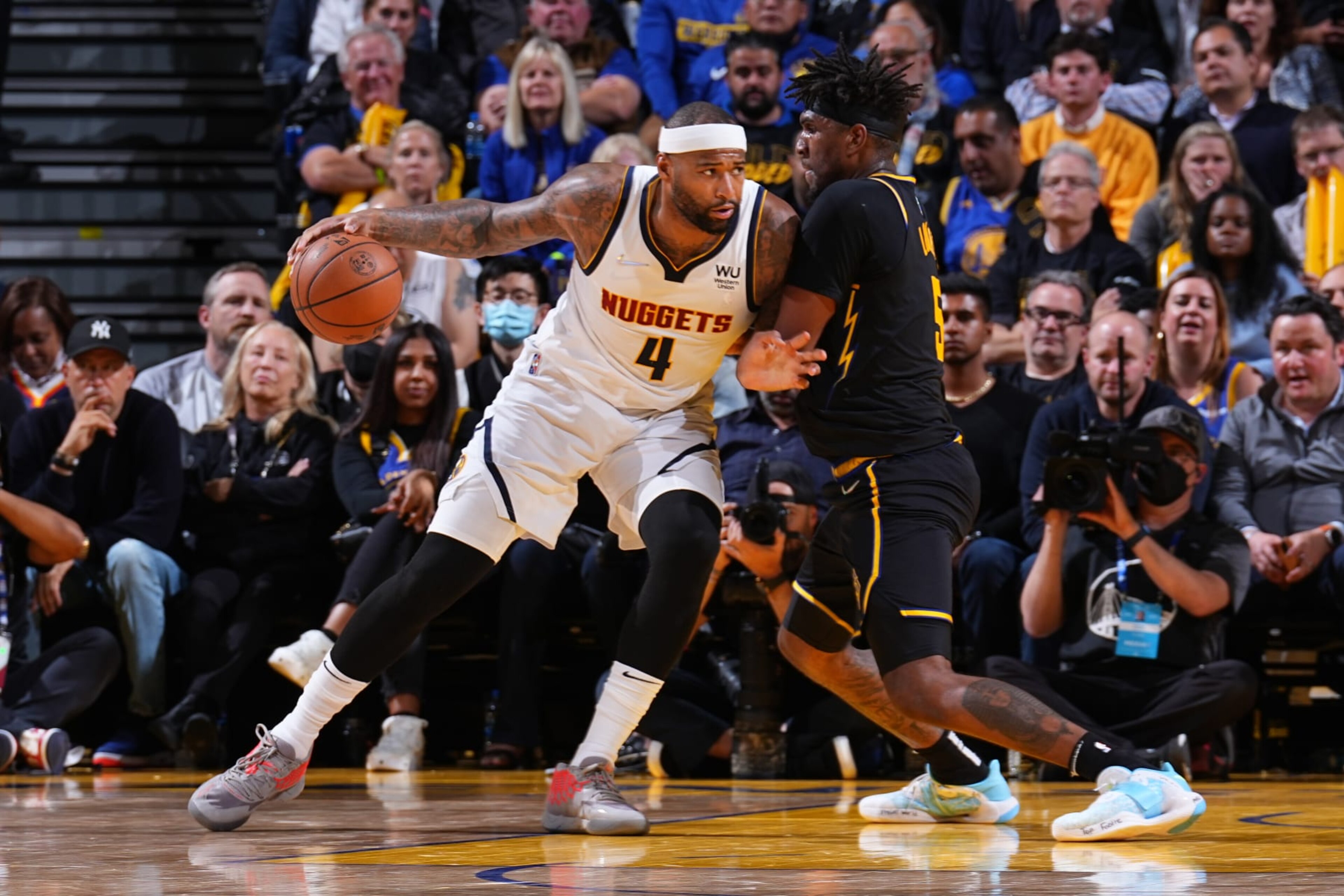SAN FRANCISCO, CA - APRIL 27: Kevon Looney #5 of the Golden State Warriors plays defense on DeMarcus Cousins #4 of the Denver Nuggets during Round 1 Game 5 of the 2022 NBA Playoffs on April 27, 2022 at Chase Center in San Francisco, California. NOTE TO USER: User expressly acknowledges and agrees that, by downloading and or using this photograph, user is consenting to the terms and conditions of Getty Images License Agreement. Mandatory Copyright Notice: Copyright 2022 NBAE (Photo by Garrett Ellwood/NBAE via Getty Images)