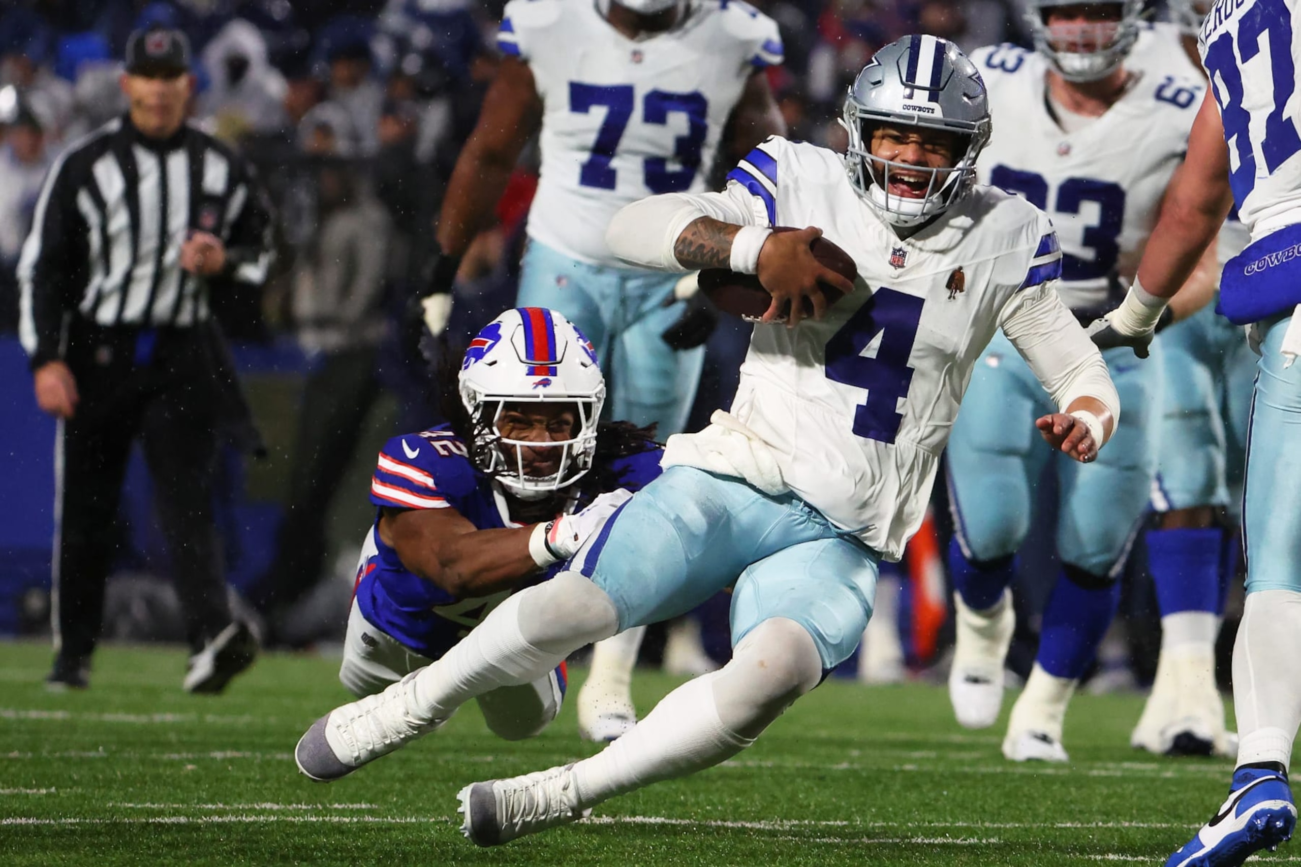ORCHARD PARK, NEW YORK - DECEMBER 17: Dorian Williams #42 of the Buffalo Bills tackles Dak Prescott #4 of the Dallas Cowboys during the fourth quarter at Highmark Stadium on December 17, 2023 in Orchard Park, New York. (Photo by Timothy T Ludwig/Getty Images)