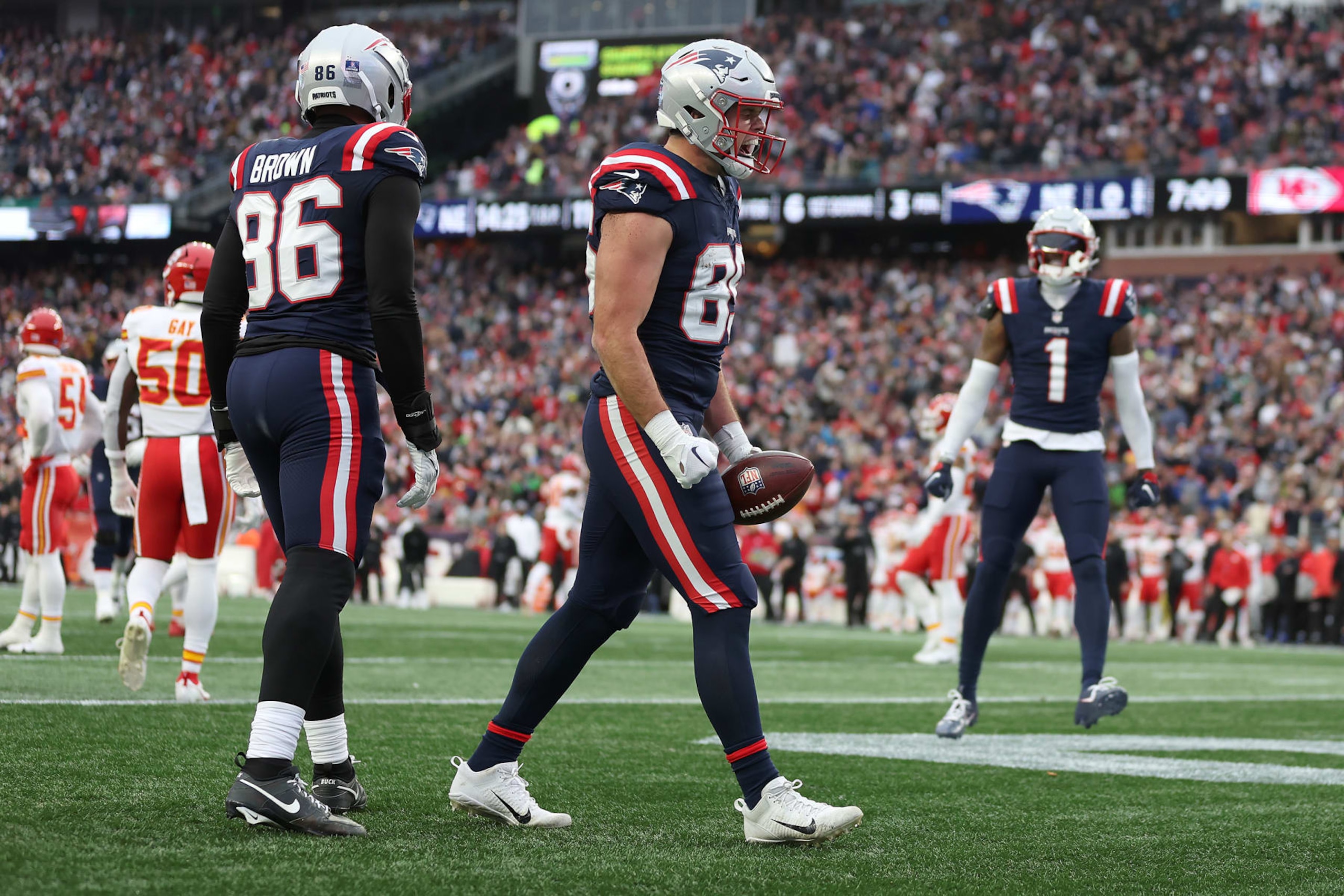 FOXBOROUGH, MASSACHUSETTS - DECEMBER 17: Pharaoh Brown #86 and Hunter Henry #85 of the New England Patriots celebrate after Henry's receiving touchdown during the second quarter against the Kansas City Chiefs at Gillette Stadium on December 17, 2023 in Foxborough, Massachusetts. (Photo by Maddie Meyer/Getty Images)