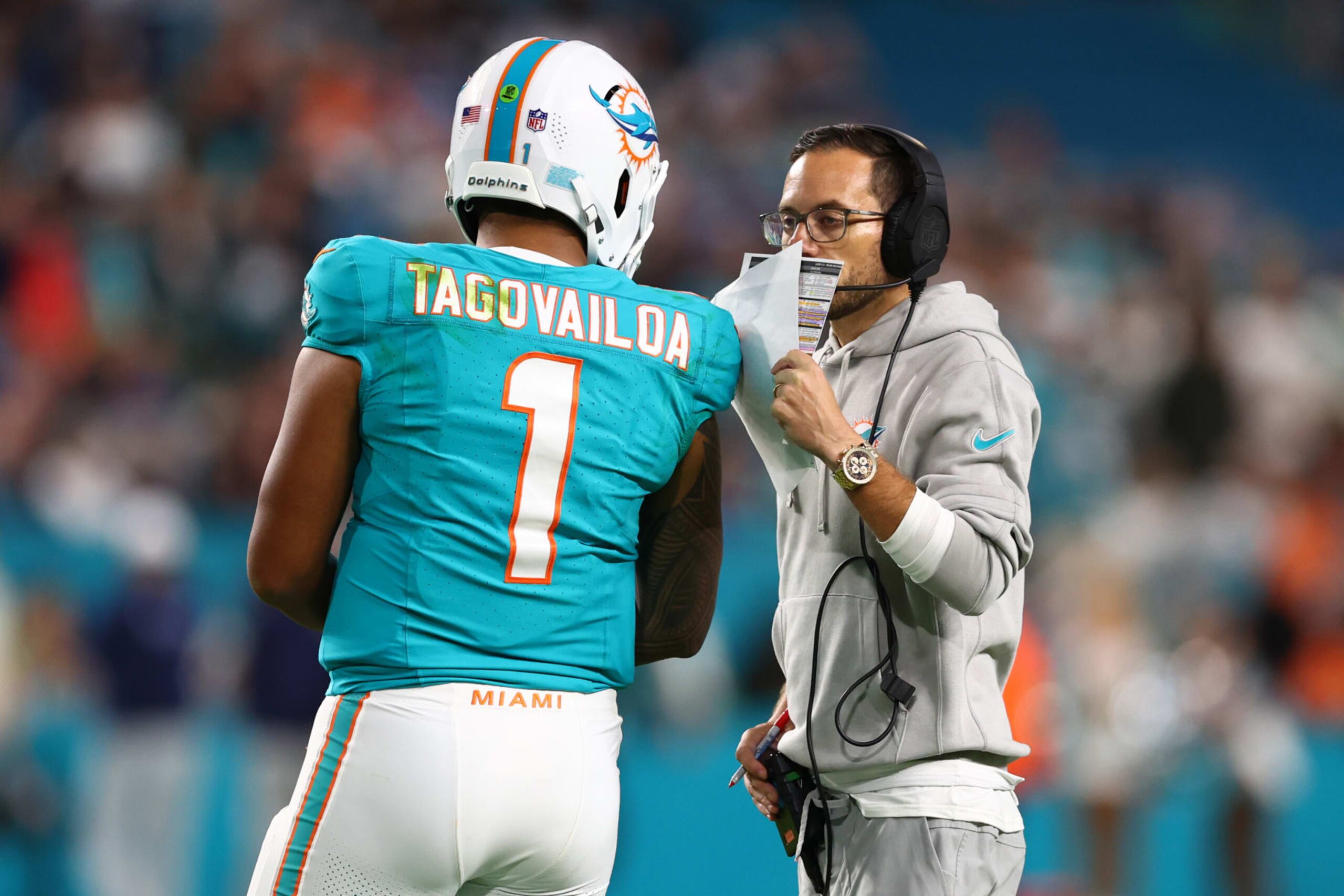 MIAMI GARDENS, FLORIDA - DECEMBER 11: Tua Tagovailoa #1 and head coach Mike McDaniel of the Miami Dolphins speak on the field during the fourth quarter of the game against the Tennessee Titans at Hard Rock Stadium on December 11, 2023 in Miami Gardens, Florida. (Photo by Megan Briggs/Getty Images)
