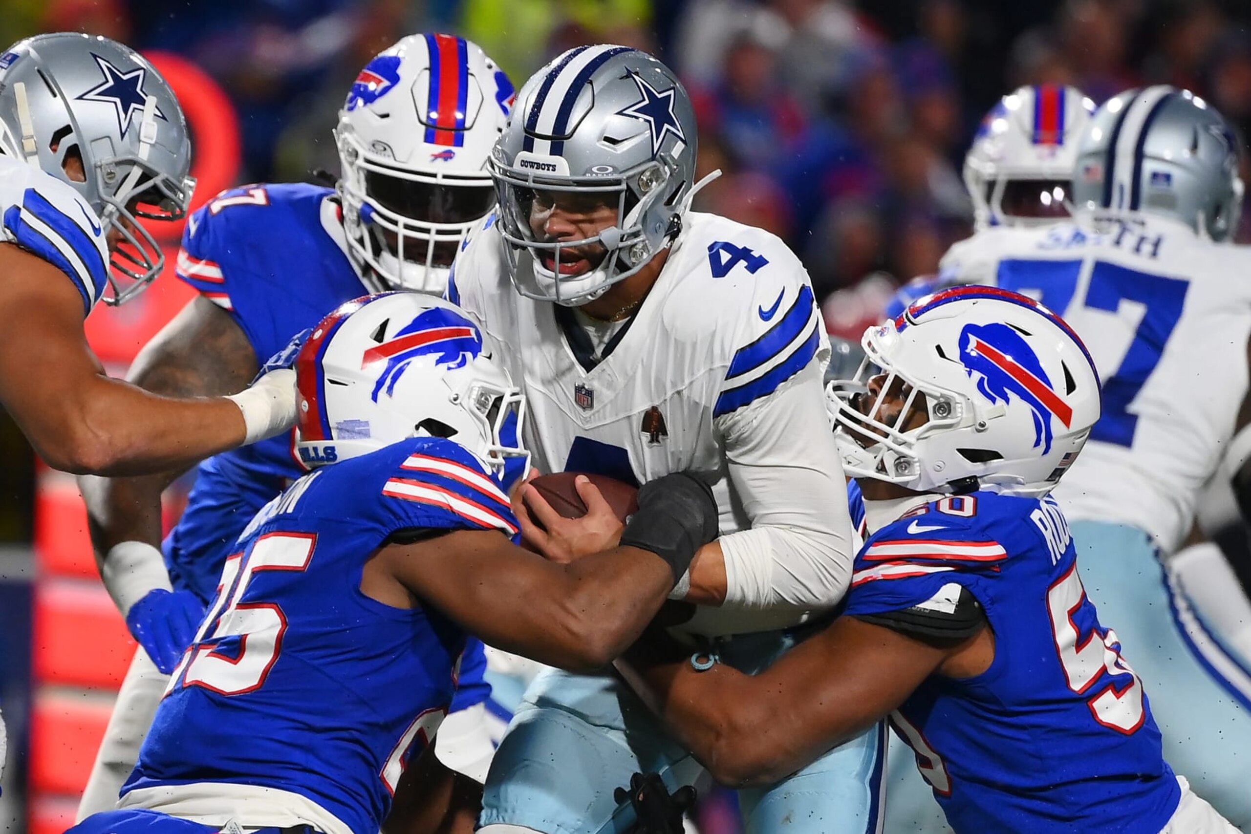 ORCHARD PARK, NEW YORK - DECEMBER 17: Tyrel Dodson #25 and Greg Rousseau #50 both of the Buffalo Bills sack Dak Prescott #4 of the Dallas Cowboys during the third quarter at Highmark Stadium on December 17, 2023 in Orchard Park, New York. (Photo by Rich Barnes/Getty Images) ORCHARD PARK, NEW YORK - DECEMBER 17: Tyrel Dodson #25 and Greg Rousseau #50 both of the Buffalo Bills sack Dak Prescott #4 of the Dallas Cowboys during the third quarter at Highmark Stadium on December 17, 2023 in Orchard Park, New York. (Photo by Rich Barnes/Getty Images)