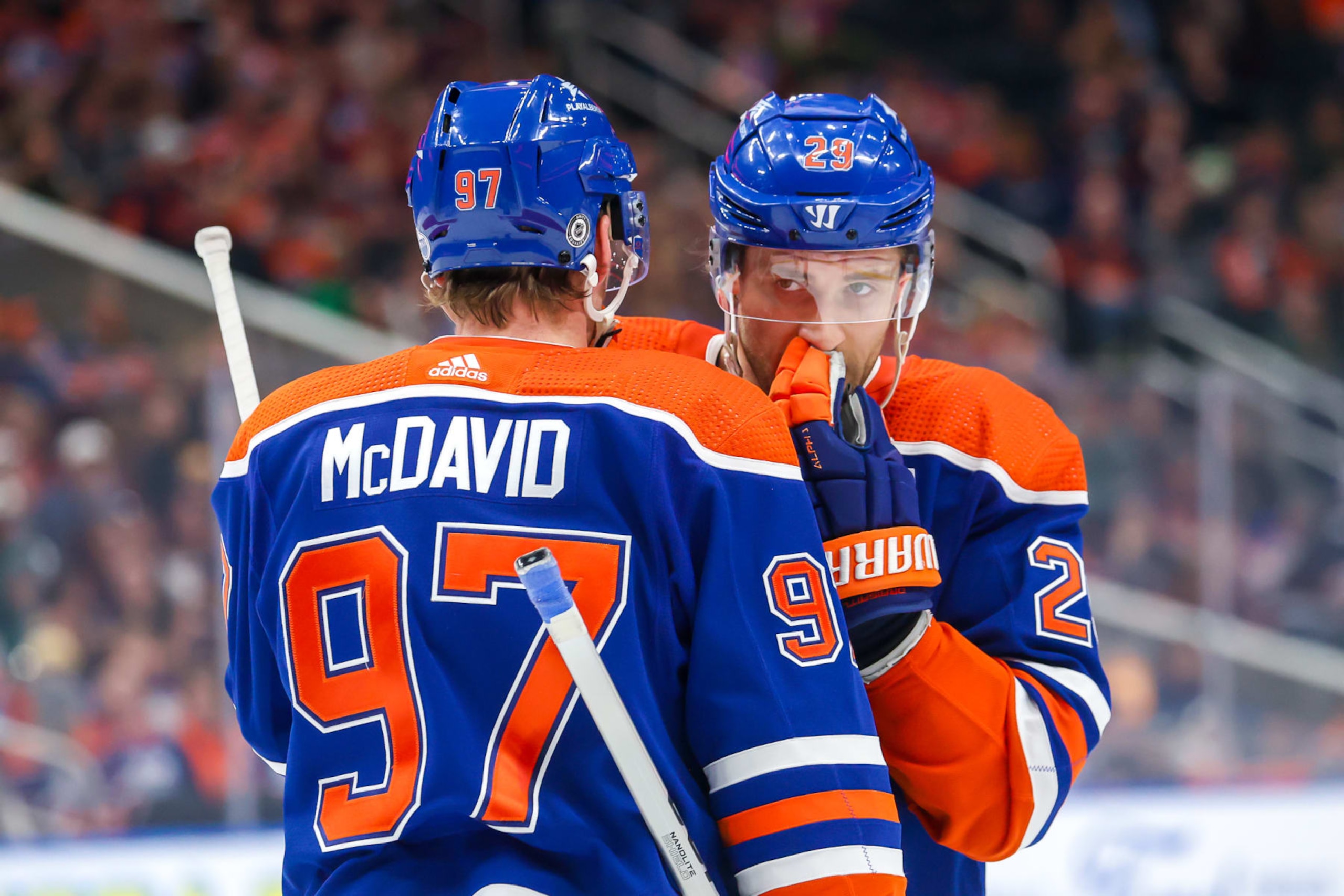 EDMONTON, CANADA - NOVEMBER 04: Connor McDavid #97 and Leon Draisaitl #29 of the Edmonton Oilers discuss strategy during a first period stoppage of play against the Nashville Predators at Rogers Place on November 04, 2023 in Edmonton, Alberta, Canada. (Photo by Jonathan Kozub/NHLI via Getty Images)