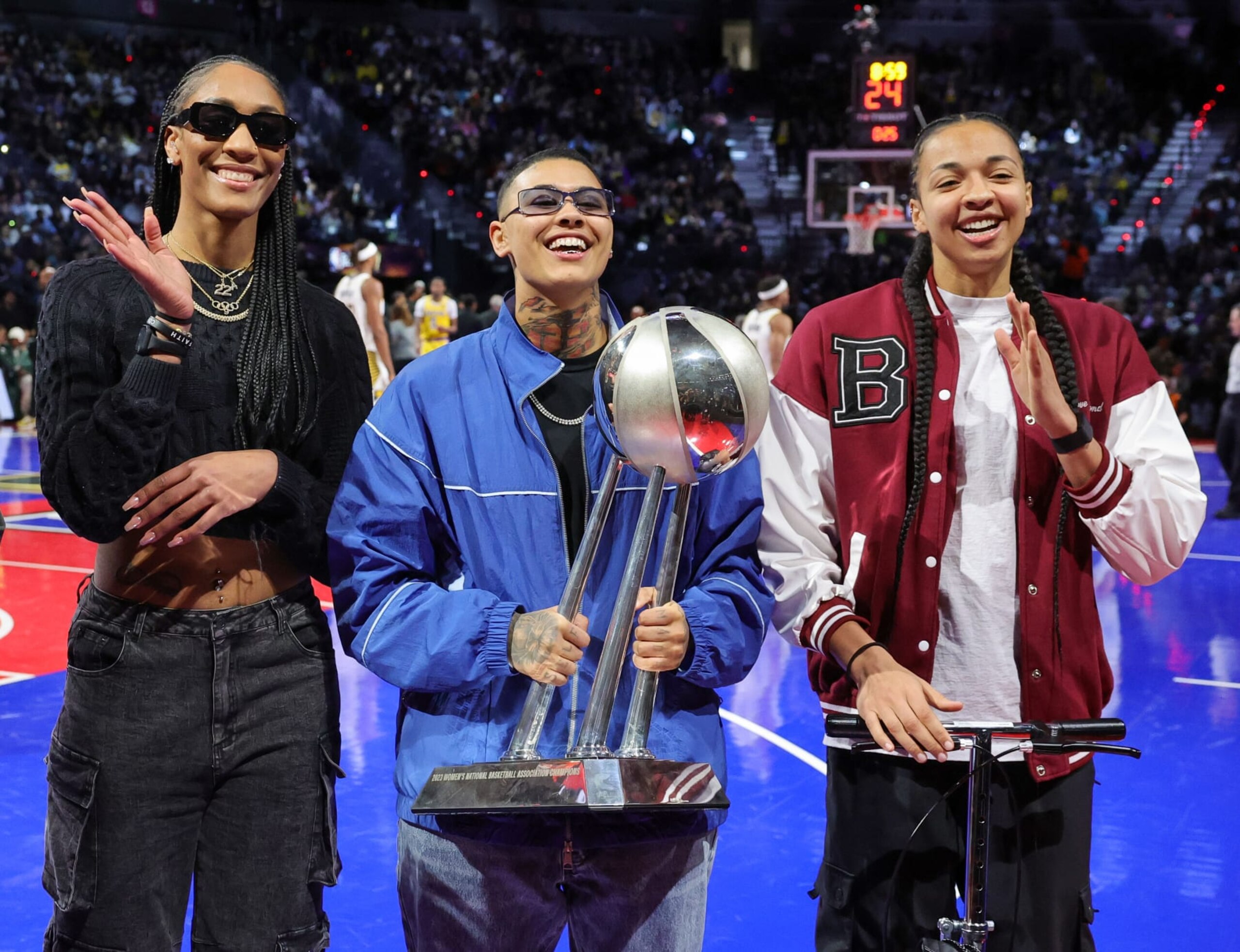 LAS VEGAS, NEVADA - DECEMBER 09: (L-R) A'ja Wilson, Kierstan Bell and Kiah Stokes of the Las Vegas Aces pose with the WNBA championship trophy during a break in the second quarter of the championship game of the inaugural NBA In-Season Tournament between the Indiana Pacers and the Los Angeles Lakers at T-Mobile Arena on December 09, 2023 in Las Vegas, Nevada. The Lakers defeated the Pacers 123-109. NOTE TO USER: User expressly acknowledges and agrees that, by downloading and or using this photograph, User is consenting to the terms and conditions of the Getty Images License Agreement. (Photo by Ethan Miller/Getty Images) LAS VEGAS, NEVADA - DECEMBER 09: (L-R) A'ja Wilson, Kierstan Bell and Kiah Stokes of the Las Vegas Aces pose with the WNBA championship trophy during a break in the second quarter of the championship game of the inaugural NBA In-Season Tournament between the Indiana Pacers and the Los Angeles Lakers at T-Mobile Arena on December 09, 2023 in Las Vegas, Nevada. The Lakers defeated the Pacers 123-109. NOTE TO USER: User expressly acknowledges and agrees that, by downloading and or using this photograph, User is consenting to the terms and conditions of the Getty Images License Agreement. (Photo by Ethan Miller/Getty Images)