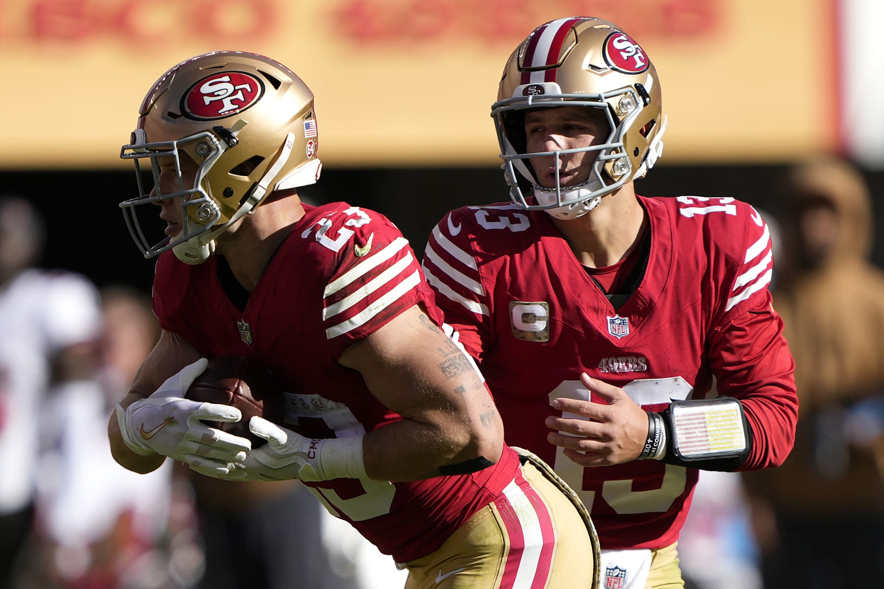 SANTA CLARA, CALIFORNIA - NOVEMBER 19: Brock Purdy #13 of the San Francisco 49ers hands off the ball to Christian McCaffrey #23 of the San Francisco 49ers during the first quarter of a game against the Tampa Bay Buccaneers at Levi's Stadium on November 19, 2023 in Santa Clara, California. (Photo by Thearon W. Henderson/Getty Images)