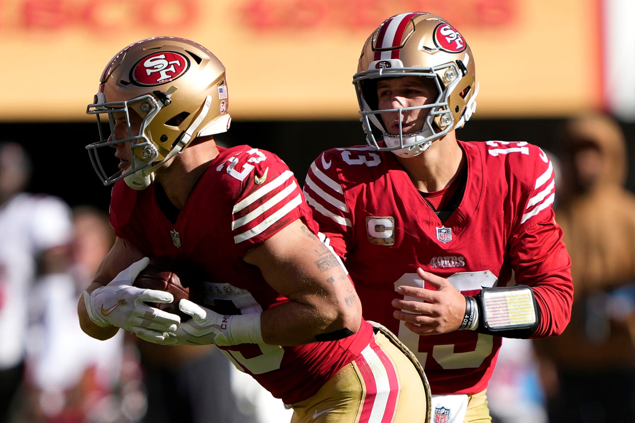 SANTA CLARA, CALIFORNIA - NOVEMBER 19: Brock Purdy #13 of the San Francisco 49ers hands off the ball to Christian McCaffrey #23 of the San Francisco 49ers during the first quarter of a game against the Tampa Bay Buccaneers at Levi's Stadium on November 19, 2023 in Santa Clara, California. (Photo by Thearon W. Henderson/Getty Images)