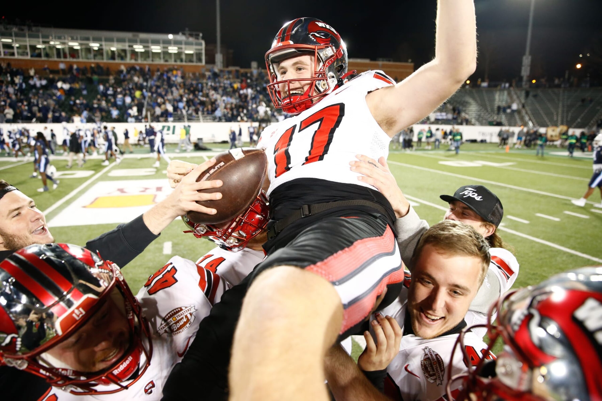 CHARLOTTE, NORTH CAROLINA - DECEMBER 18: Teammates lift Lucas Carneiro #17 of the Western Kentucky Hilltoppers after scoring the game winning field goal in overtime to defeat the Old Dominion Monarchs during the Famous Toastery Bowl at Jerry Richardson Stadium on December 18, 2023 in Charlotte, North Carolina. (Photo by Isaiah Vazquez/Getty Images) CHARLOTTE, NORTH CAROLINA - DECEMBER 18: Teammates lift Lucas Carneiro #17 of the Western Kentucky Hilltoppers after scoring the game winning field goal in overtime to defeat the Old Dominion Monarchs during the Famous Toastery Bowl at Jerry Richardson Stadium on December 18, 2023 in Charlotte, North Carolina. (Photo by Isaiah Vazquez/Getty Images)