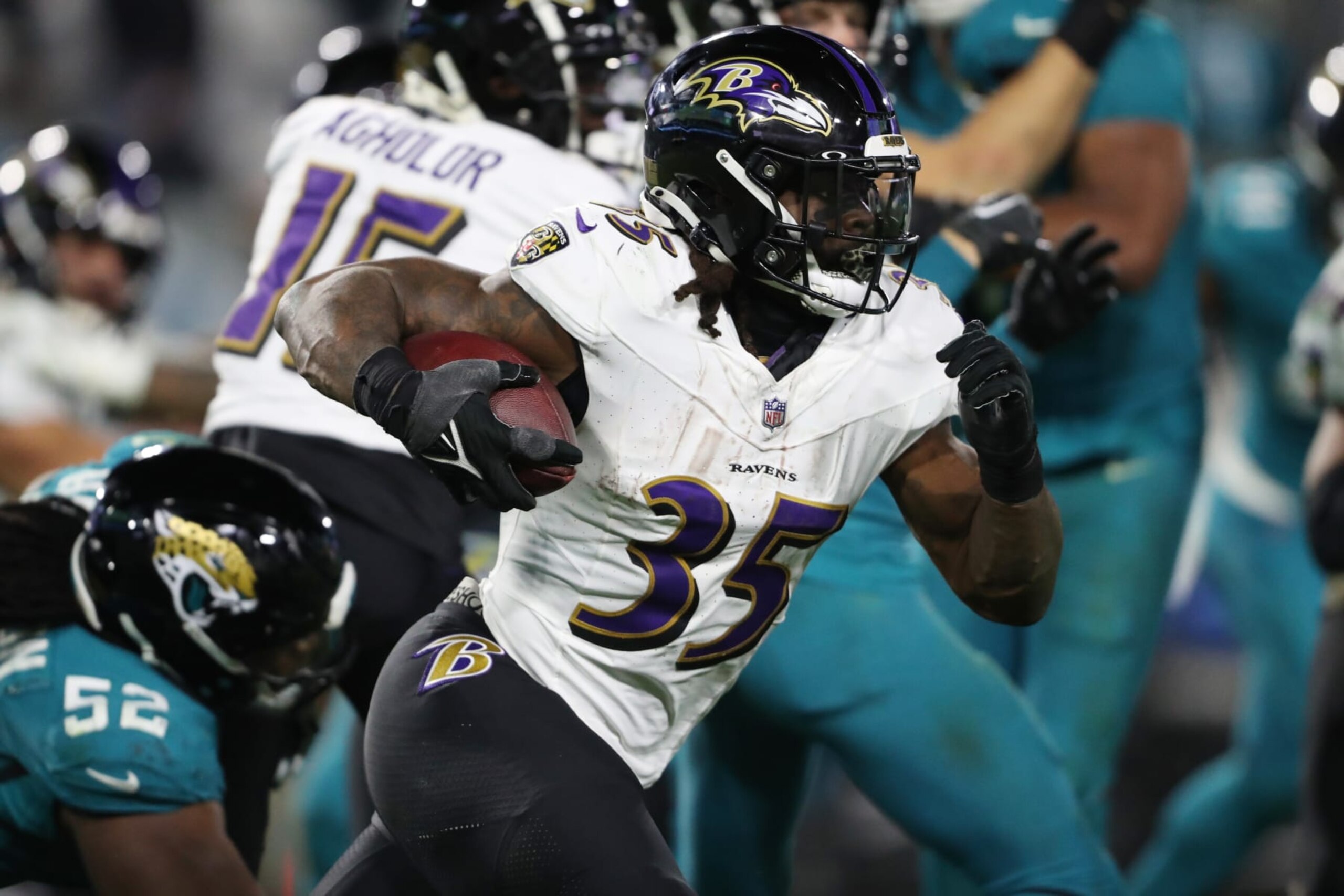 JACKSONVILLE, FLORIDA - DECEMBER 17: Gus Edwards #35 of the Baltimore Ravens runs with the ball against the Jacksonville Jaguars during the fourth quarter at EverBank Stadium on December 17, 2023 in Jacksonville, Florida. (Photo by Courtney Culbreath/Getty Images)