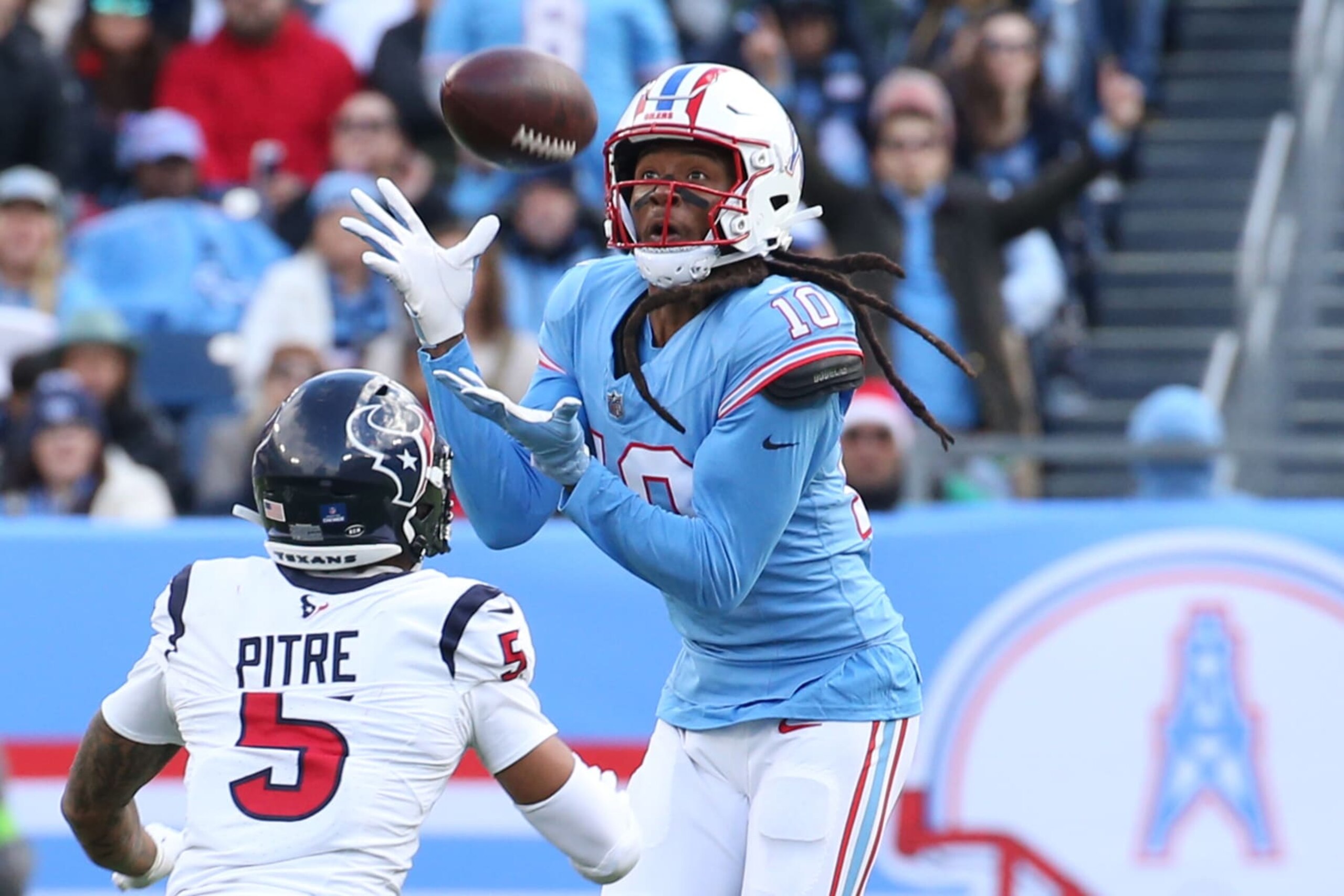 NASHVILLE, TN - DECEMBER 17: Tennessee Titans wide receiver DeAndre Hopkins (10) makes a catch over Houston Texans safety Jalen Pitre (5) during a game between the Tennessee Titans and Houston Texans, December 17, 2023 at Nissan Stadium in Nashville, Tennessee. (Photo by Matthew Maxey/Icon Sportswire via Getty Images)