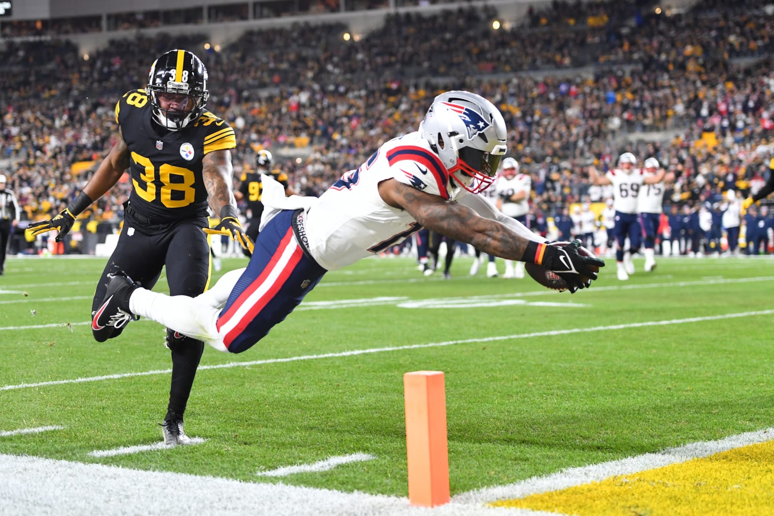 PITTSBURGH, PENNSYLVANIA - DECEMBER 07: Running back Ezekiel Elliott (15) of the New England Patriots dives for a touchdown in the first quarter against the Pittsburgh Steelers at Acrisure Stadium on December 07, 2023 in Pittsburgh, Pennsylvania. (Photo by Joe Sargent/Getty Images)