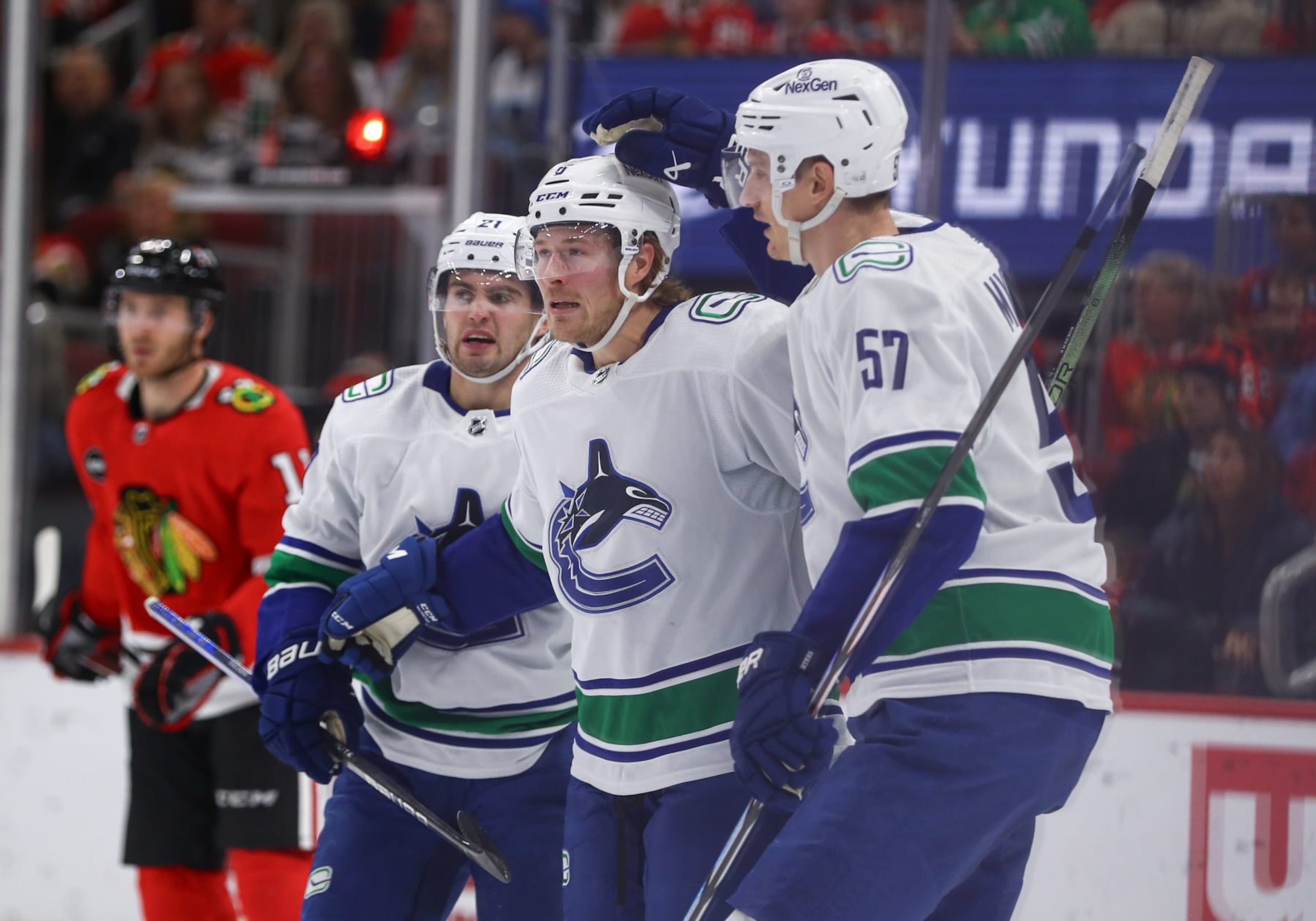CHICAGO, IL - DECEMBER 17: Brock Boeser #6 of the Vancouver Canucks celebrates with Nils Hoglander #21 of the Vancouver Canucks and Tyler Myers #57 of the Vancouver Canucks after scoring a goal during the second period against the Chicago Blackhawks at the United Center on December, 17, 2023 in Chicago, Illinois. (Photo by Melissa Tamez/Icon Sportswire via Getty Images)