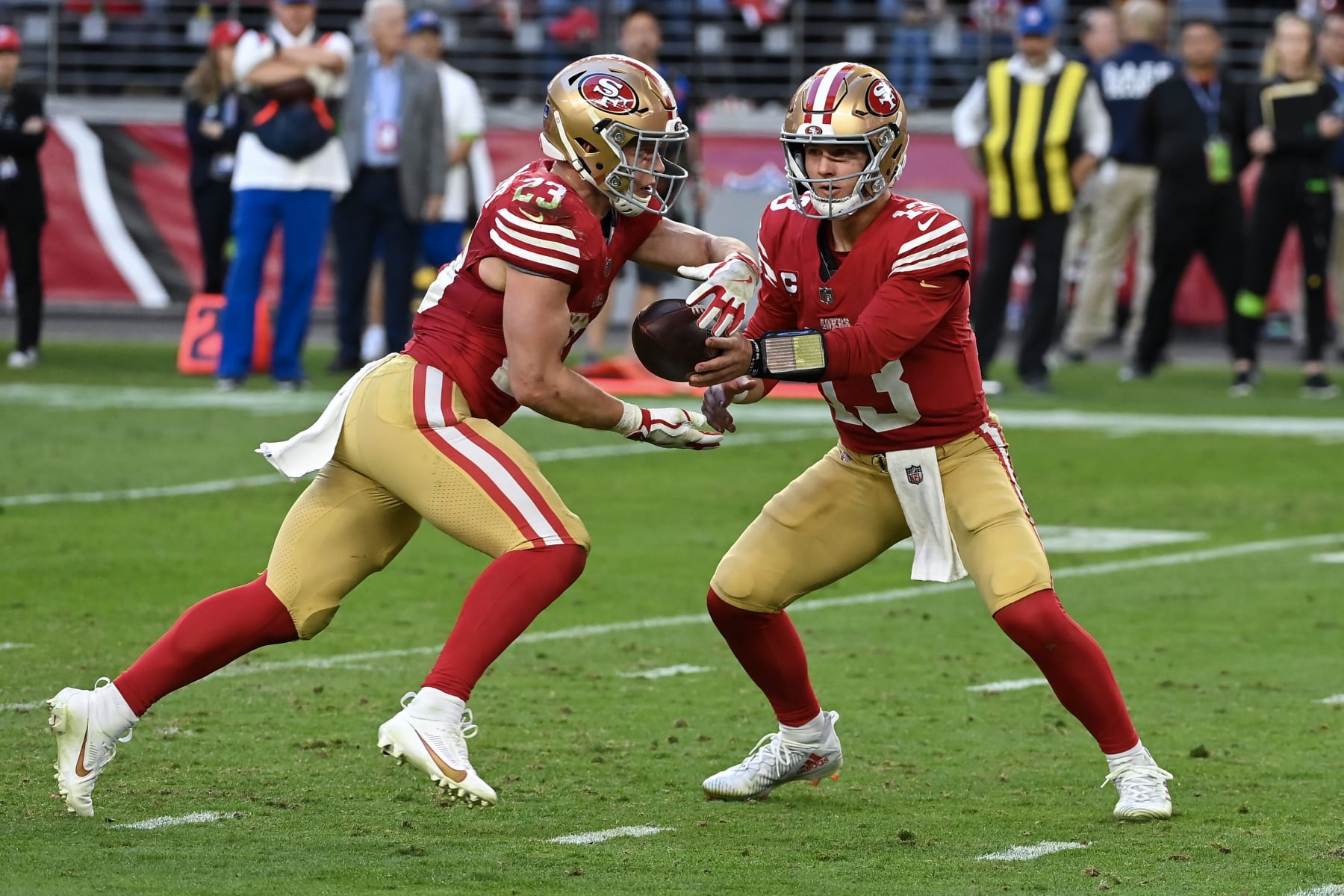 GLENDALE, ARIZONA - DECEMBER 17: Brock Purdy #13 of the San Francisco 49ers hands the ball off to Christian McCaffrey #23 of the San Francisco 49ers during the fourth quarter against the Arizona Cardinals at State Farm Stadium on December 17, 2023 in Glendale, Arizona. (Photo by Norm Hall/Getty Images)