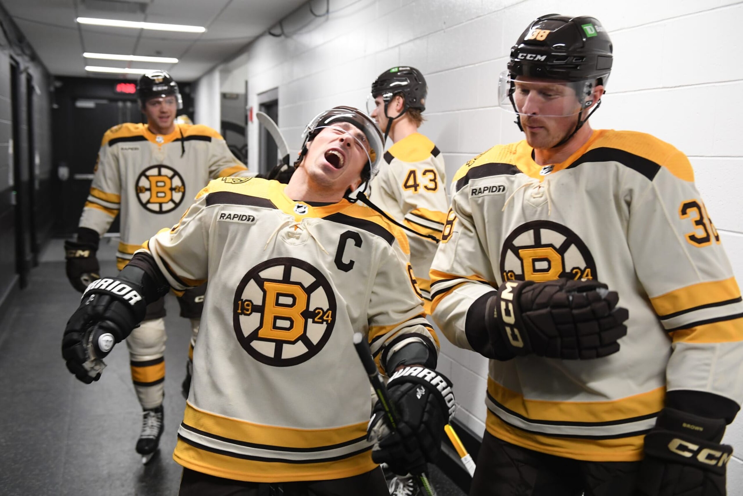 BOSTON, MASSACHUSETTS - DECEMBER 16: Brad Marchand #63 and Patrick Brown #38 of the Boston Bruins in the hallway before the game against the New York Rangers on December 16, 2023 at the TD Garden in Boston, Massachusetts. (Photo by Steve Babineau/NHLI via Getty Images)