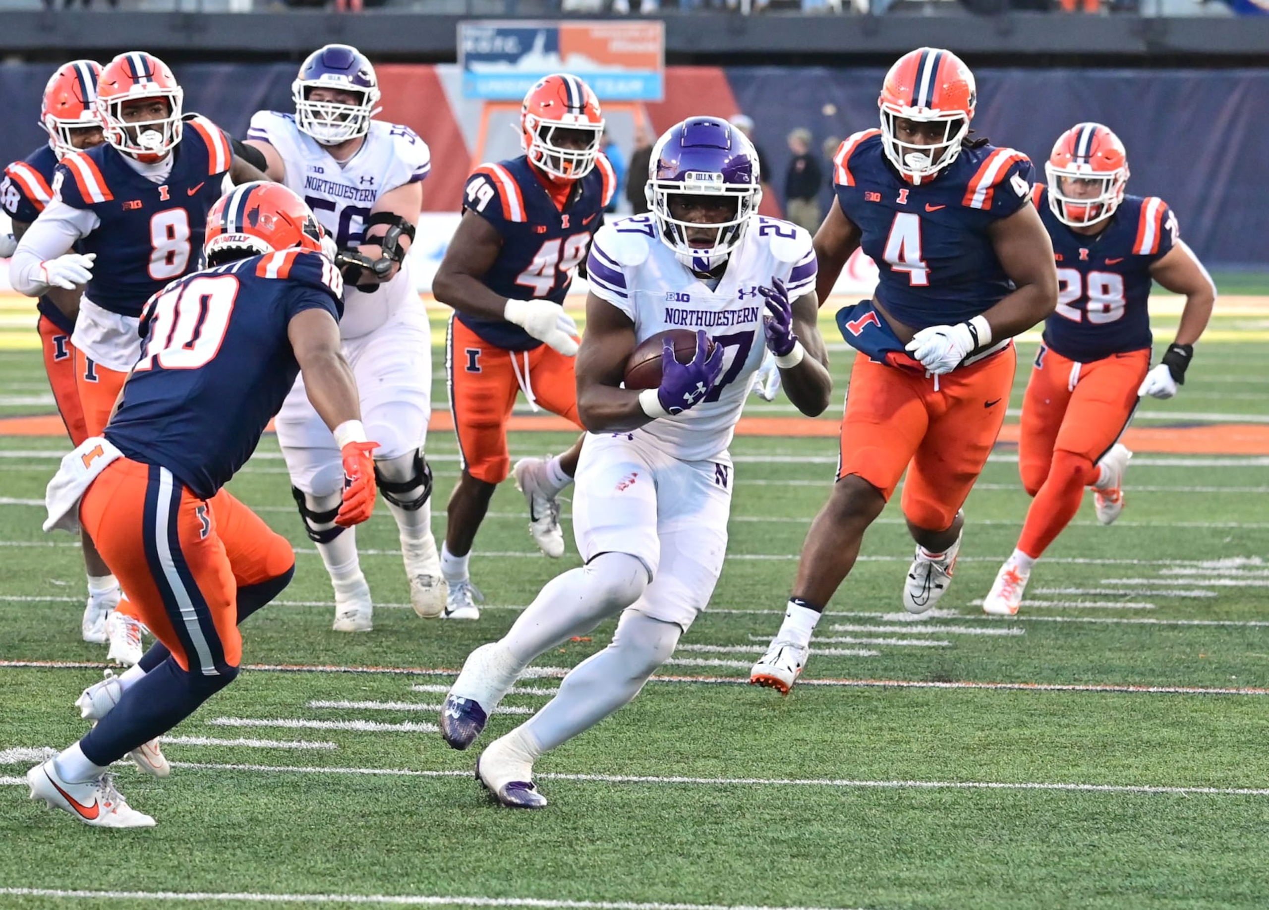 CHAMPAIGN, IL - NOVEMBER 25: Northwestern running back Anthony Tyus III (27) eludes a hist of Illini tacklers as he runs the ball during a college football game between the Northwestern Wildcats and the Illinois Fighting Illini on November 25, 2023, at Memorial Stadium in Champaign, IL. (Photo by Keith Gillett/Icon Sportswire via Getty Images)