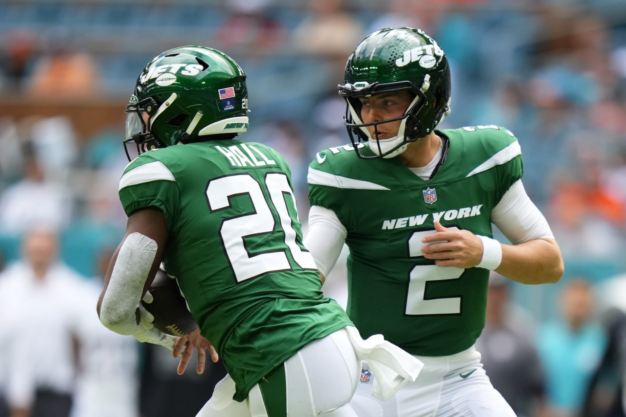 MIAMI GARDENS, FLORIDA - DECEMBER 17: Zach Wilson #2 hands the ball off to Breece Hall #20 of the New York Jets against the Miami Dolphins during the first half at Hard Rock Stadium on December 17, 2023 in Miami Gardens, Florida. (Photo by Rich Storry/Getty Images)