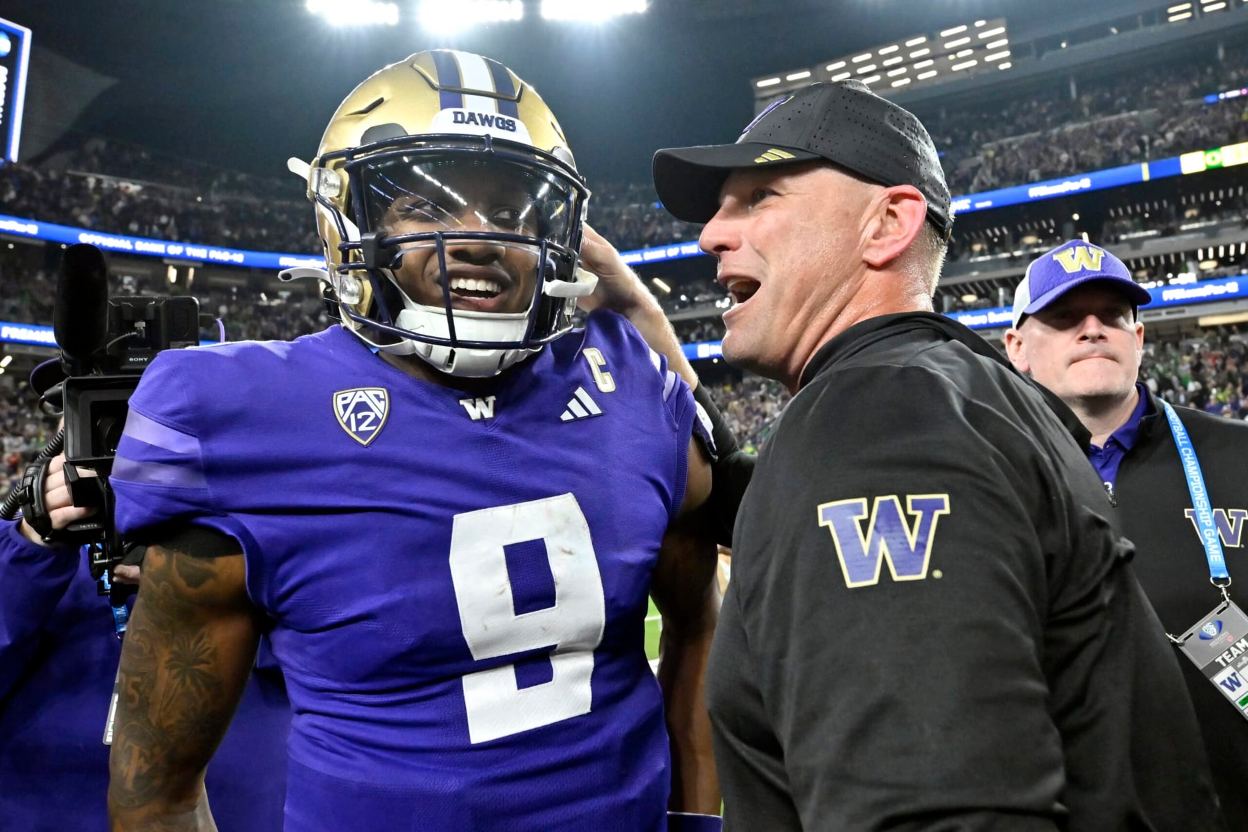 Washington quarterback Michael Penix Jr. and coach Kalen DeBoer talk after the team's victory against Oregon in the Pac-12 championship NCAA college football game Friday, Dec. 1, 2023, in Las Vegas. (AP Photo/David Becker)