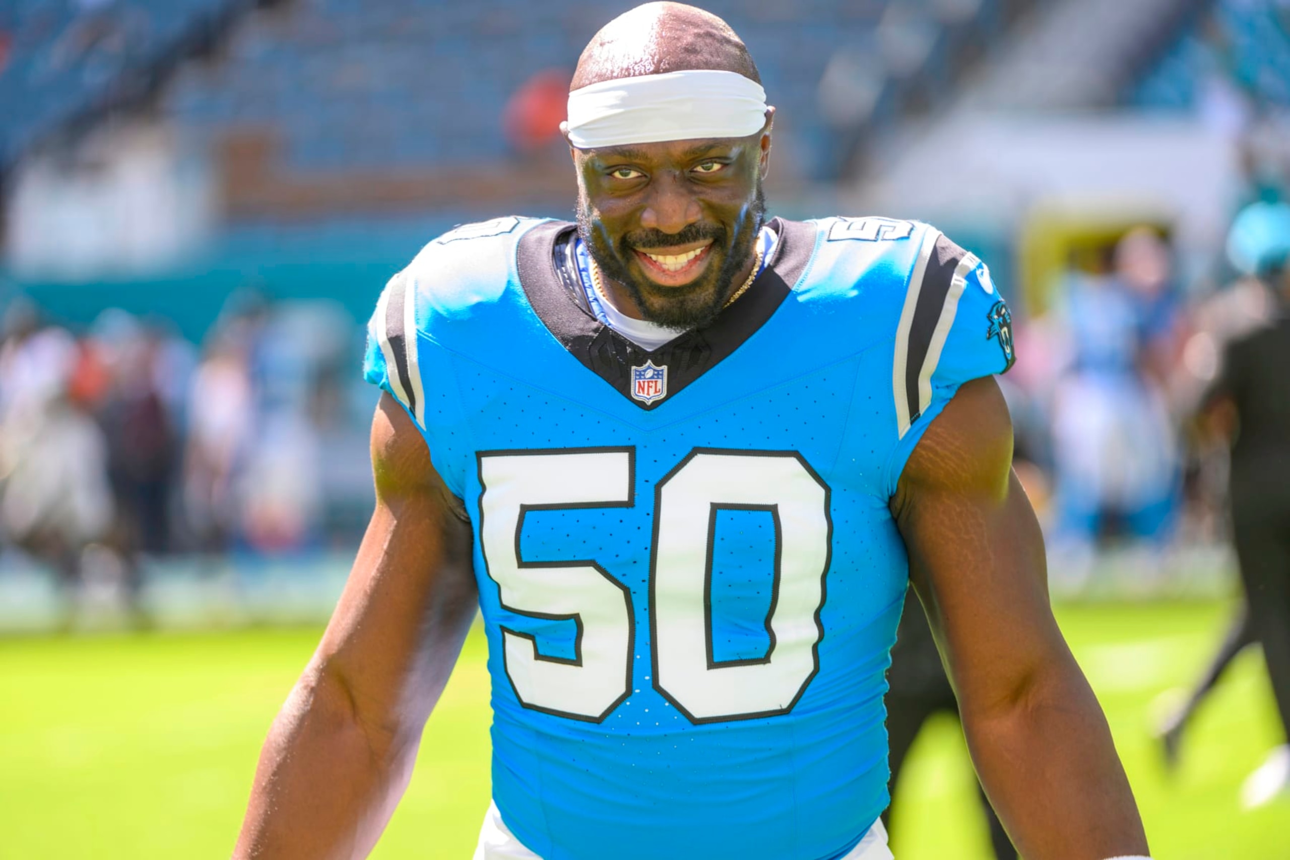 Carolina Panthers linebacker Justin Houston (50) smiles on the field before an NFL football game against and the Miami Dolphins, Sunday, Oct. 15, 2023, in Miami Gardens, Fla. (AP Photo/Doug Murray)