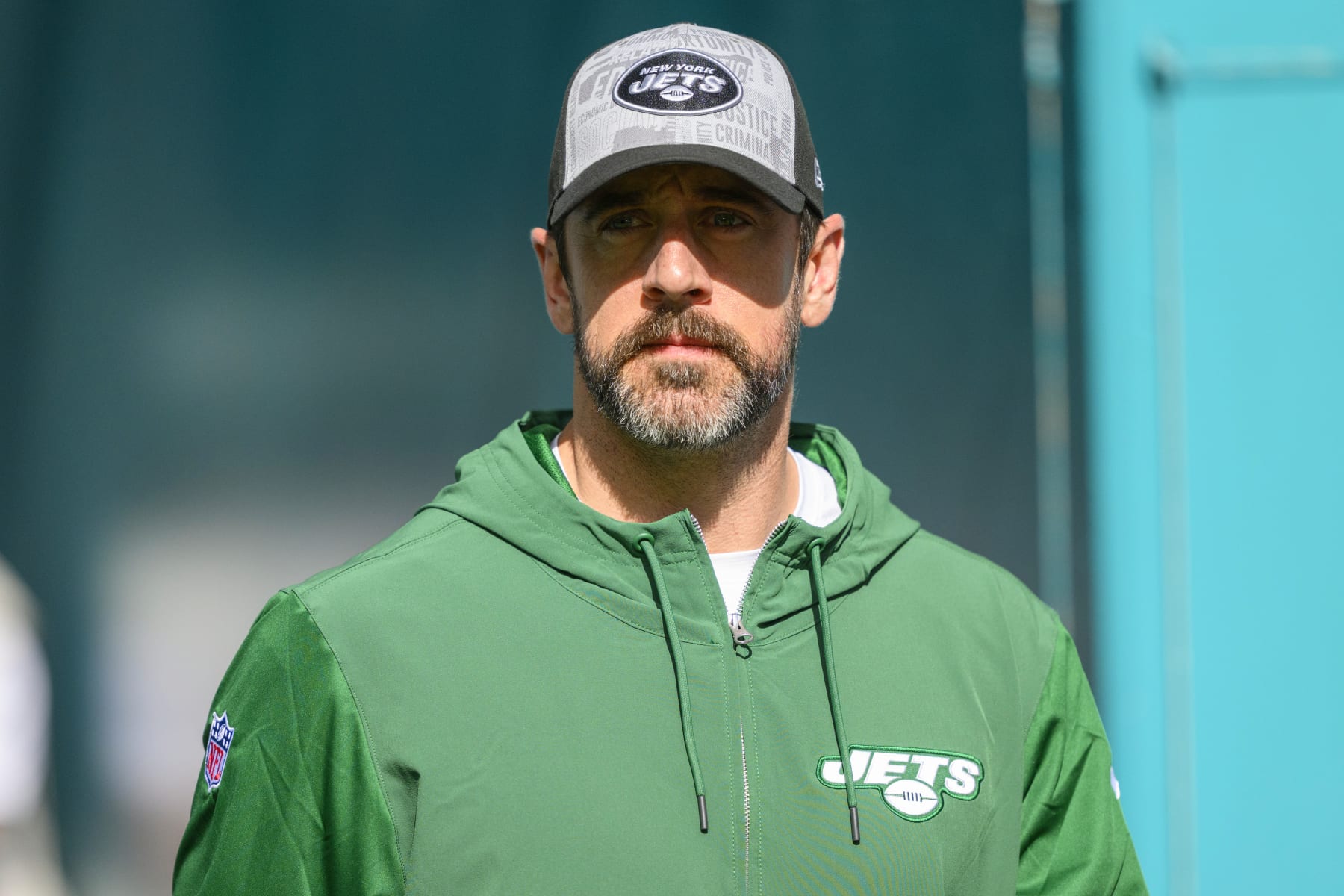 New York Jets quarterback Aaron Rodgers walks onto the field before an NFL football game against the Miami Dolphins, Sunday, Dec 17, 2023, in Miami Gardens, Fla. (AP Photo/Doug Murray)