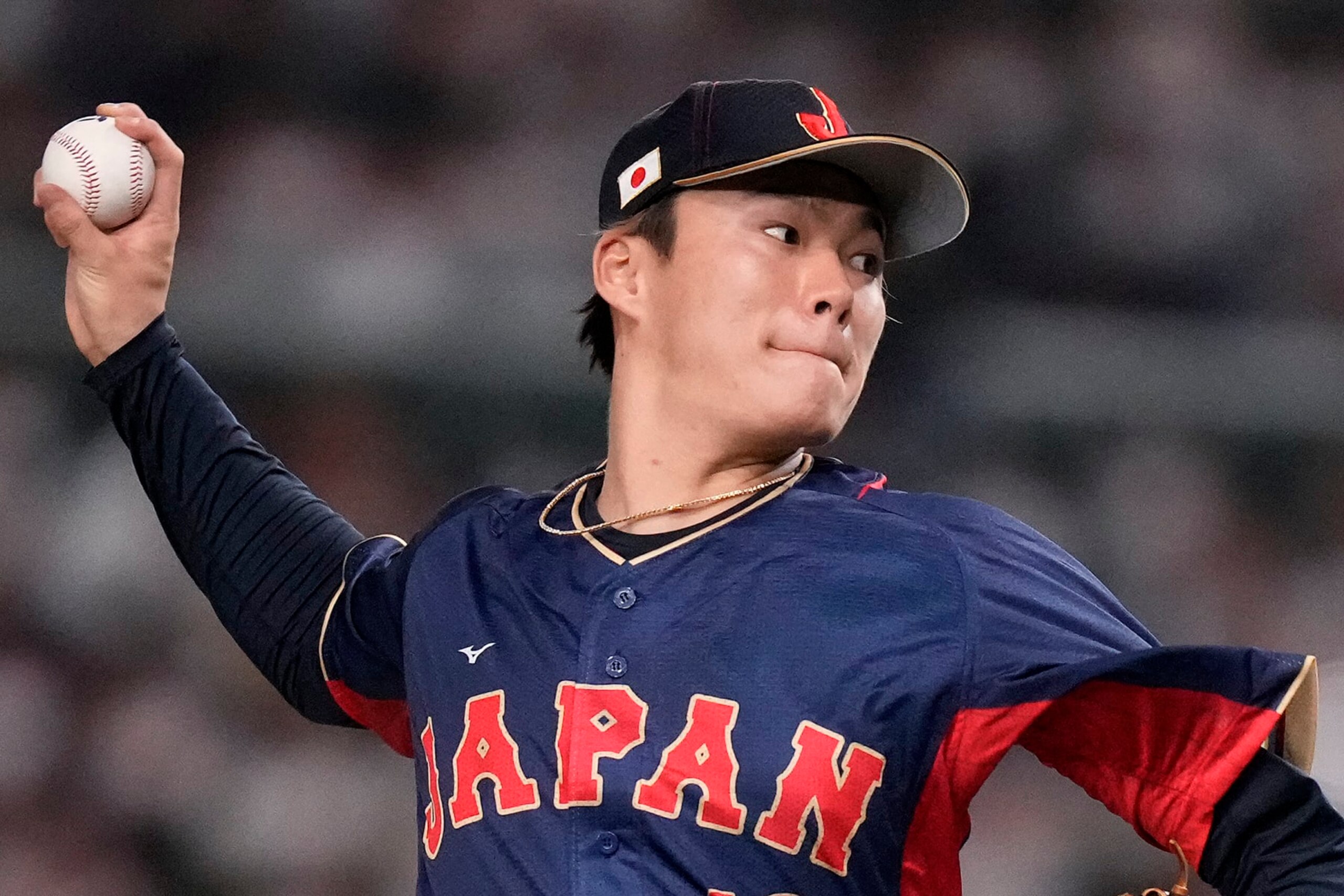 FILE - Yoshinobu Yamamoto, of Japan, pitches to Australia in the first inning of a Pool B game at the World Baseball Classic at Tokyo Dome in Tokyo, Sunday, March 12, 2023. Yamamoto will become a free agent Tuesday and major league teams can sign him through 5 p.m. EST on Jan. 4. Nippon Professional Baseball notified Major League Baseball that the 25-year-old right-hander’s club, the Orix Buffaloes, was posting him for availability to MLB teams. MLB notified the 30 teams of the posting on Monday, Nov. 20, 2023.(AP Photo/Eugene Hoshiko, File)