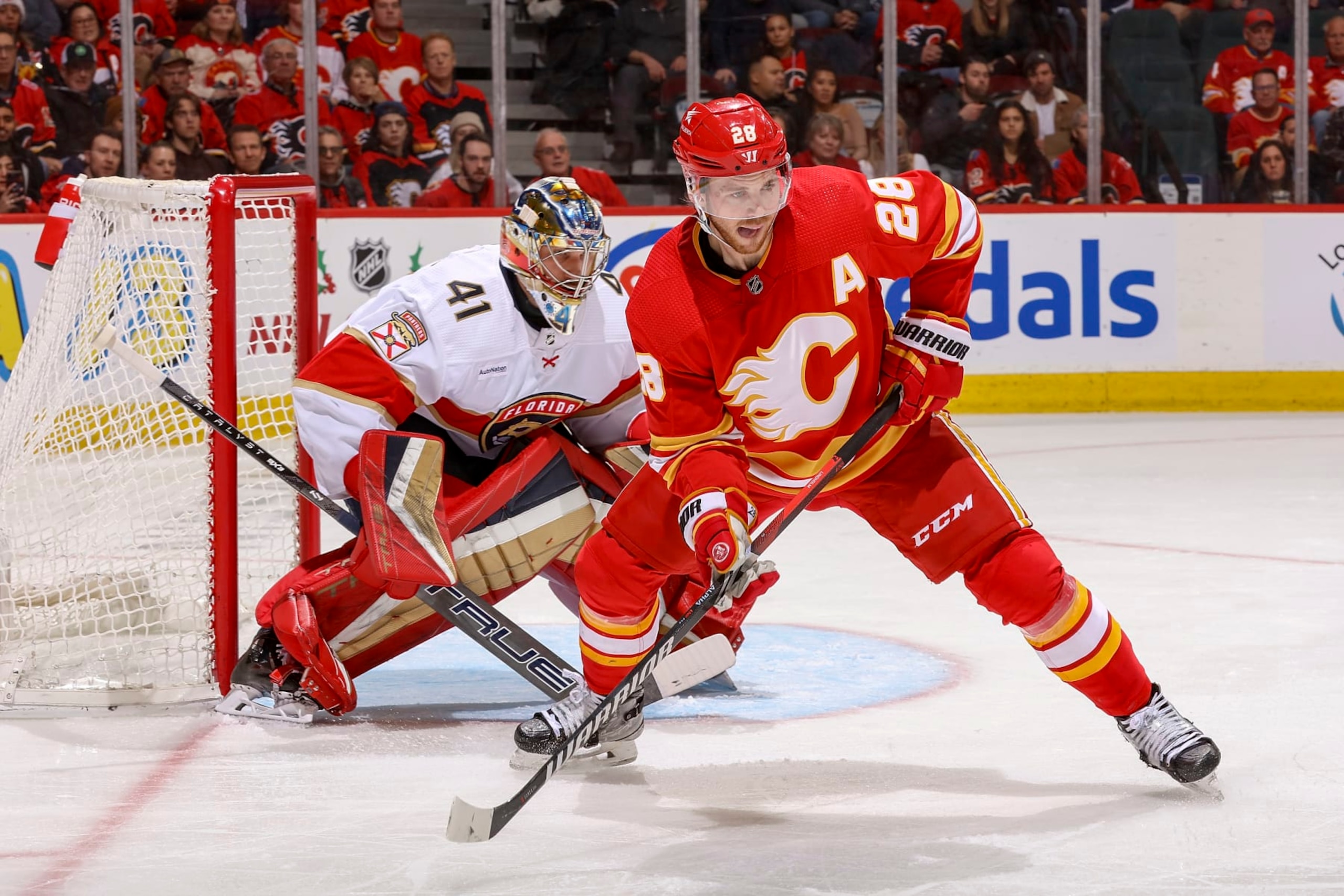 CALGARY, AB - DECEMBER 18: Elias Lindholm #28 of the Calgary Flames battles in front of the net against the Florida Panthers at Scotiabank Saddledome on December 18, 2023 in Calgary, Alberta, Canada. (Photo by Gerry Thomas/NHLI via Getty Images) CALGARY, AB - DECEMBER 18: Elias Lindholm #28 of the Calgary Flames battles in front of the net against the Florida Panthers at Scotiabank Saddledome on December 18, 2023 in Calgary, Alberta, Canada. (Photo by Gerry Thomas/NHLI via Getty Images)