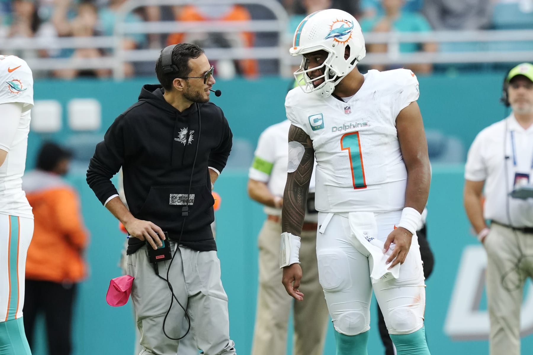 Miami Dolphins head coach Mike McDaniel talks to quarterback Tua Tagovailoa (1) during a time out in the second half of an NFL football game against the New York Jets, Sunday, Dec. 17, 2023, in Miami Gardens, Fla. (AP Photo/Rebecca Blackwell)