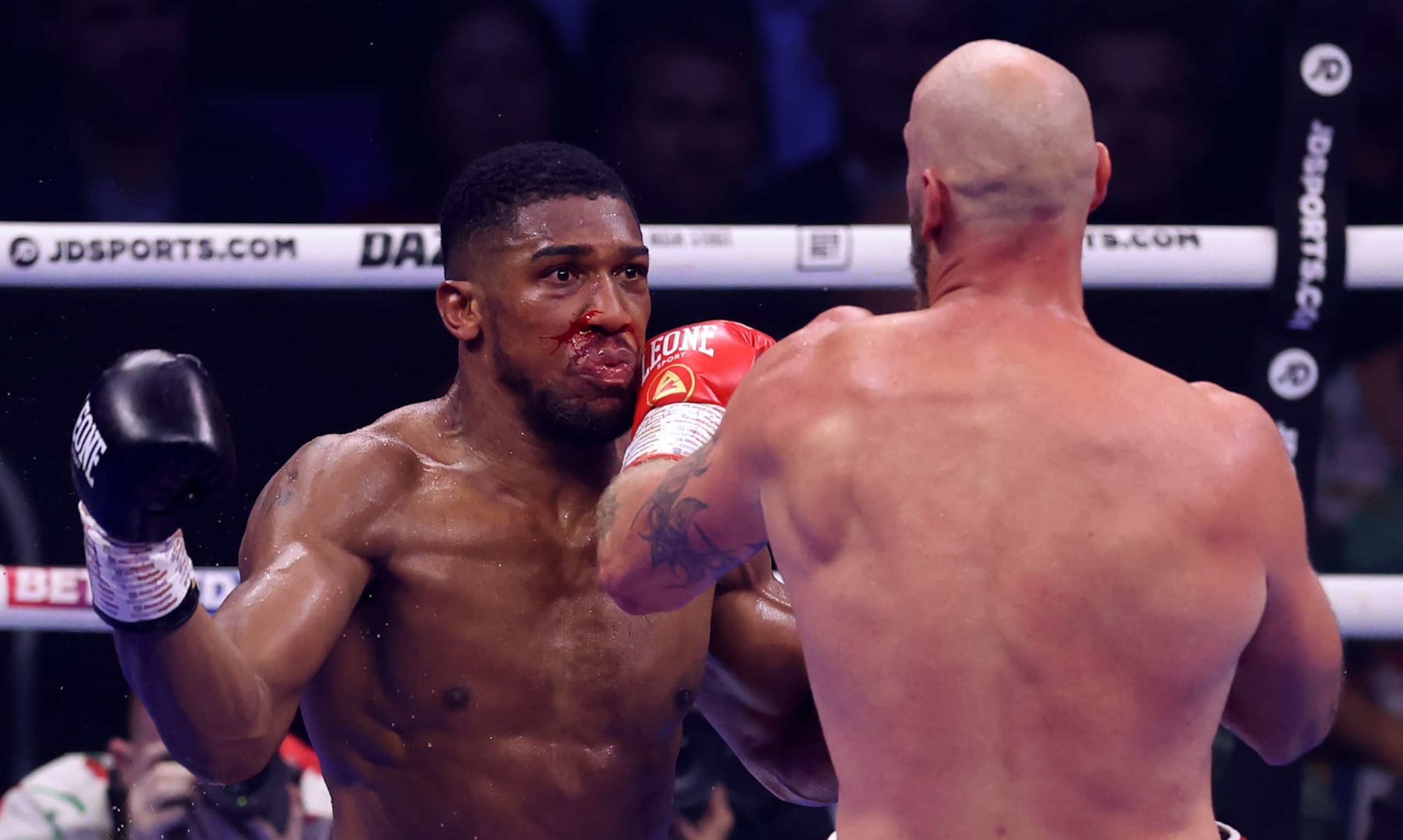 LONDON, ENGLAND - AUGUST 12: Blood is seen on the face of Anthony Joshua as he is punched by Robert Helenius during the Heavyweight fight between Anthony Joshua and Robert Helenius at The O2 Arena on August 12, 2023 in London, England. (Photo by Julian Finney/Getty Images)