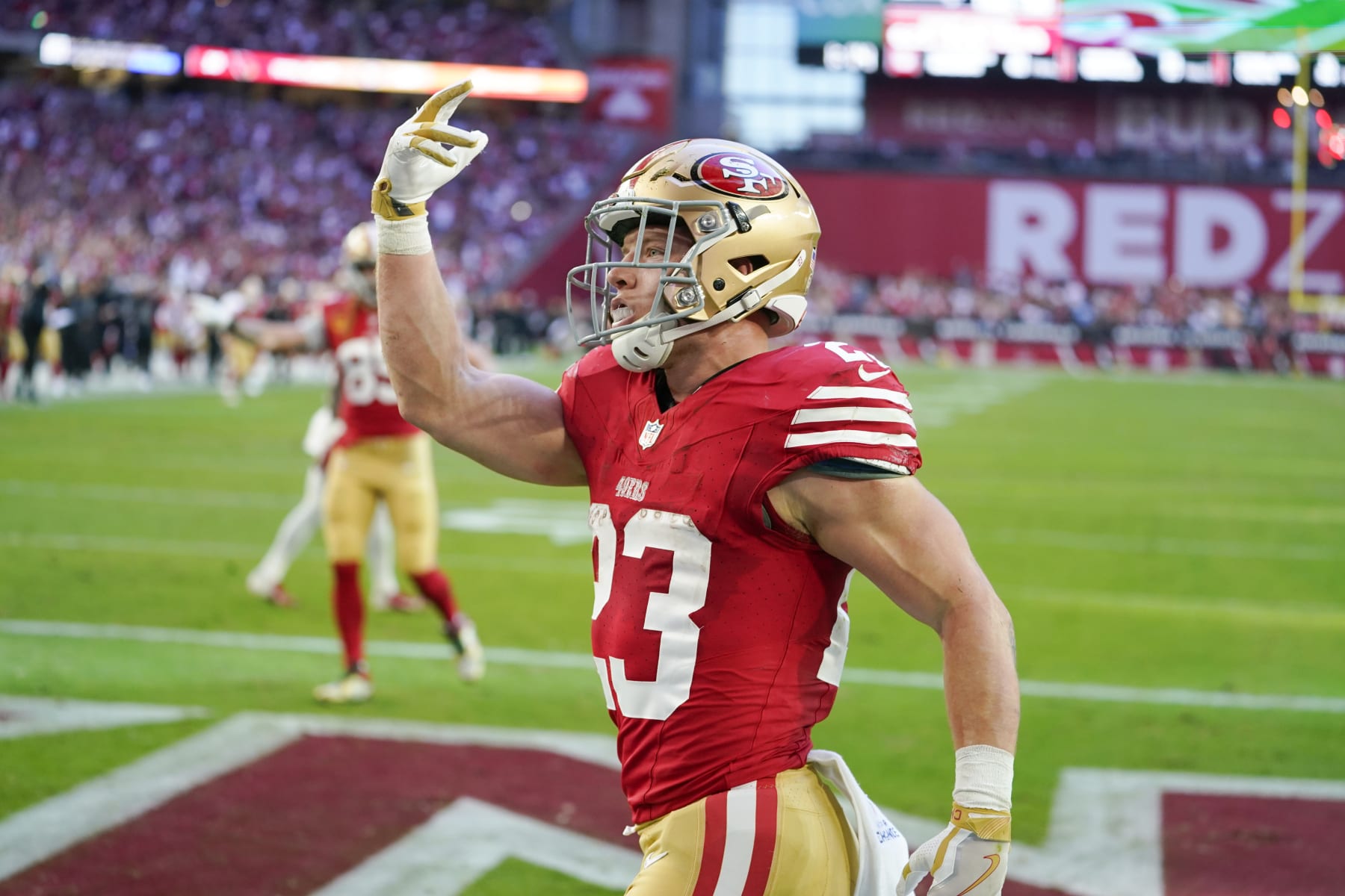 San Francisco 49ers running back Christian McCaffrey celebrates after scoring against the Arizona Cardinals during the first half of an NFL football game Sunday, Dec. 17, 2023, in Glendale, Ariz. (AP Photo/Matt York)