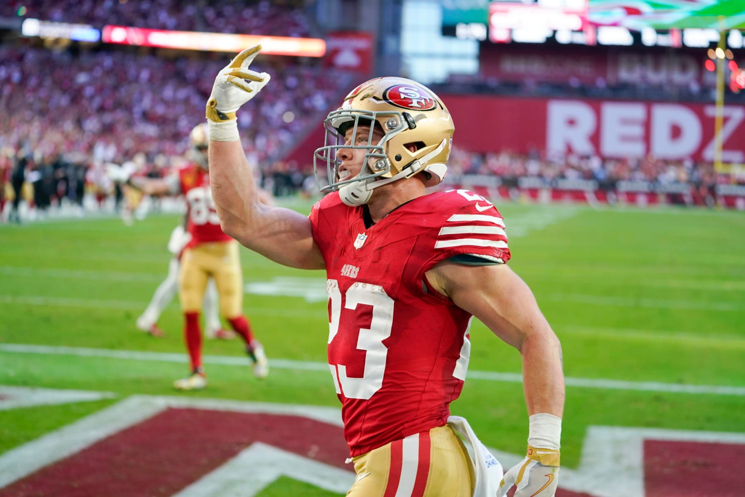 San Francisco 49ers running back Christian McCaffrey celebrates after scoring against the Arizona Cardinals during the first half of an NFL football game Sunday, Dec. 17, 2023, in Glendale, Ariz. (AP Photo/Matt York)