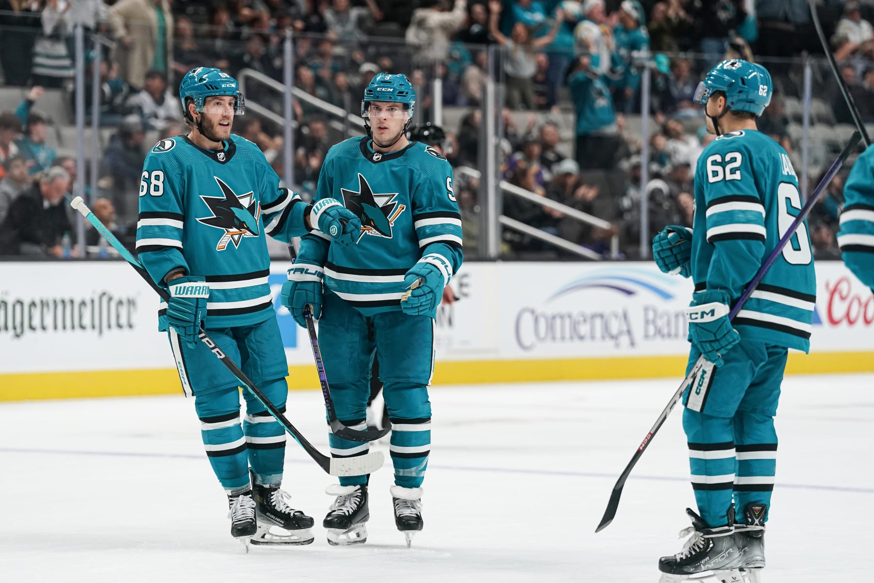 SAN JOSE, CA - DECEMBER 19: Jacob MacDonald #9, Mike Hoffman #68 and Kevin Labanc #62 of the San Jose Sharks celebrate scoring a goal against the Los Angeles Kings at SAP Center on December 19, 2023 in San Jose, California. (Photo by Kavin Mistry/NHLI via Getty Images)