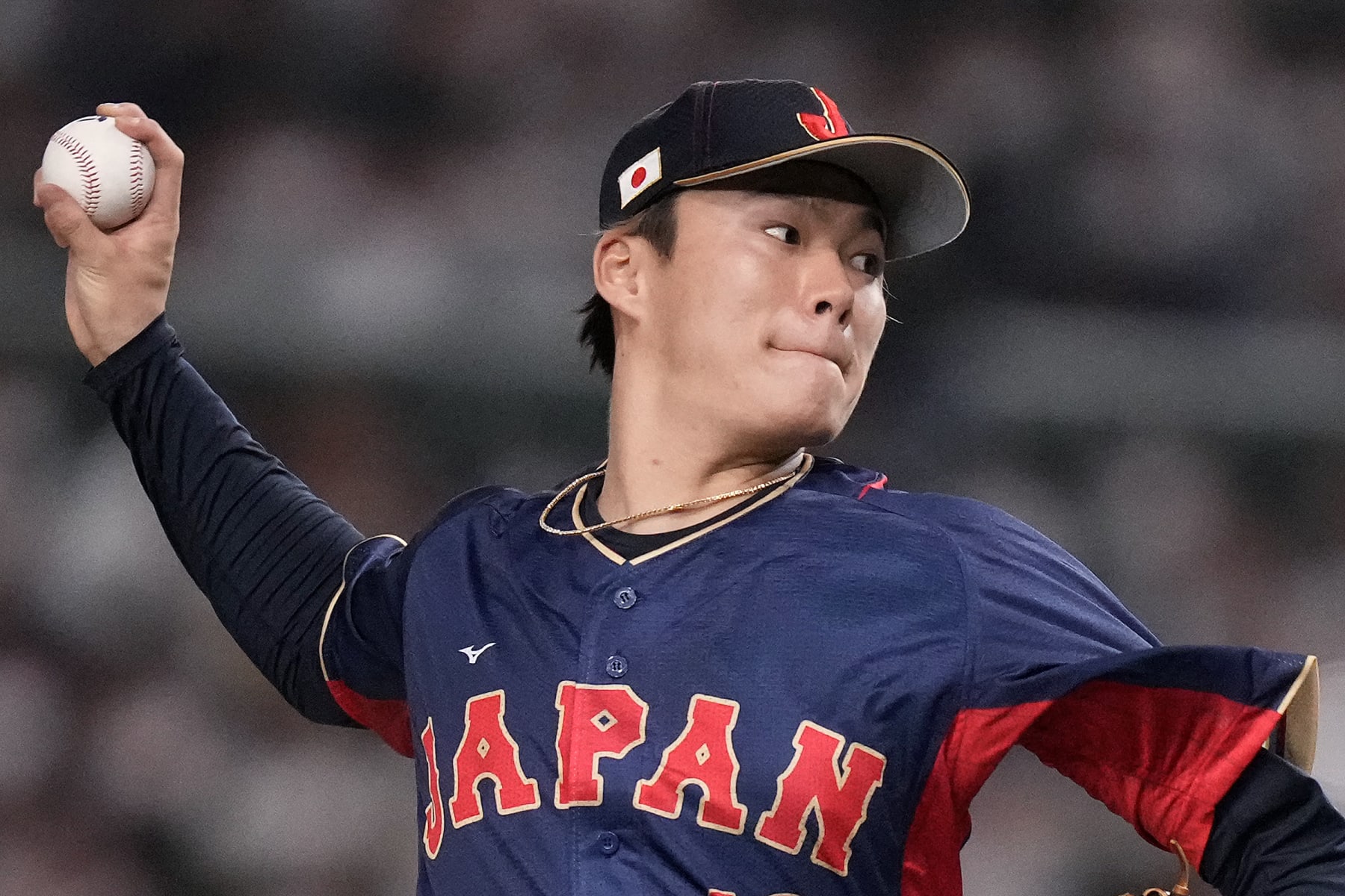 Yoshinobu Yamamoto of Japan pitches to Australia in the 1rst innning during their Pool B game at the World Baseball Classic at the Tokyo Dome Sunday, March 12, 2023, in Tokyo. (AP Photo/Eugene Hoshiko)